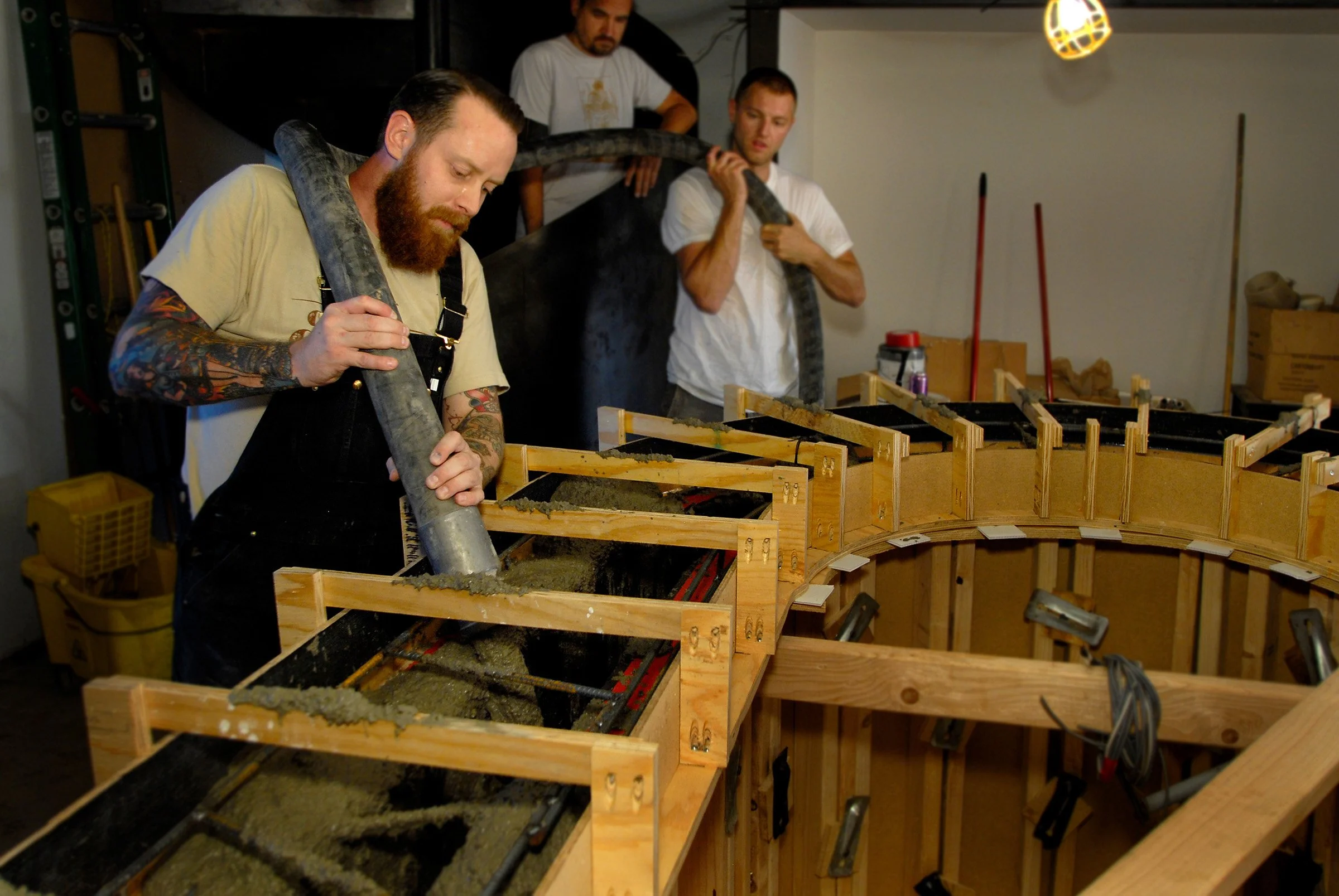 Brandon Gore pumping concrete into a fabric form for a cast in place wall and countertop.