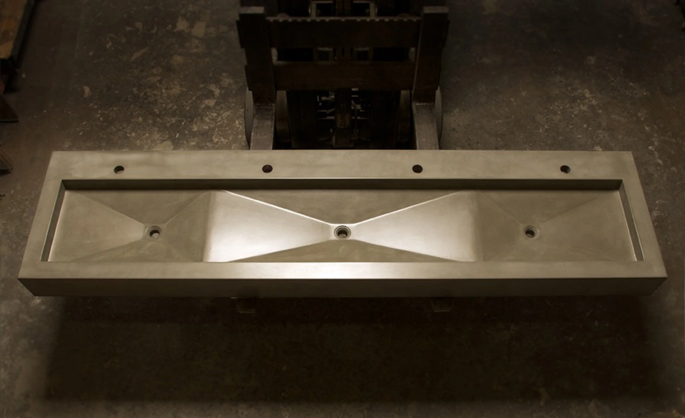 Custom restaurant bathroom sink with three basins for high-capacity use. Handcrafted in the USA from durable GFRC concrete for luxury hospitality projects.