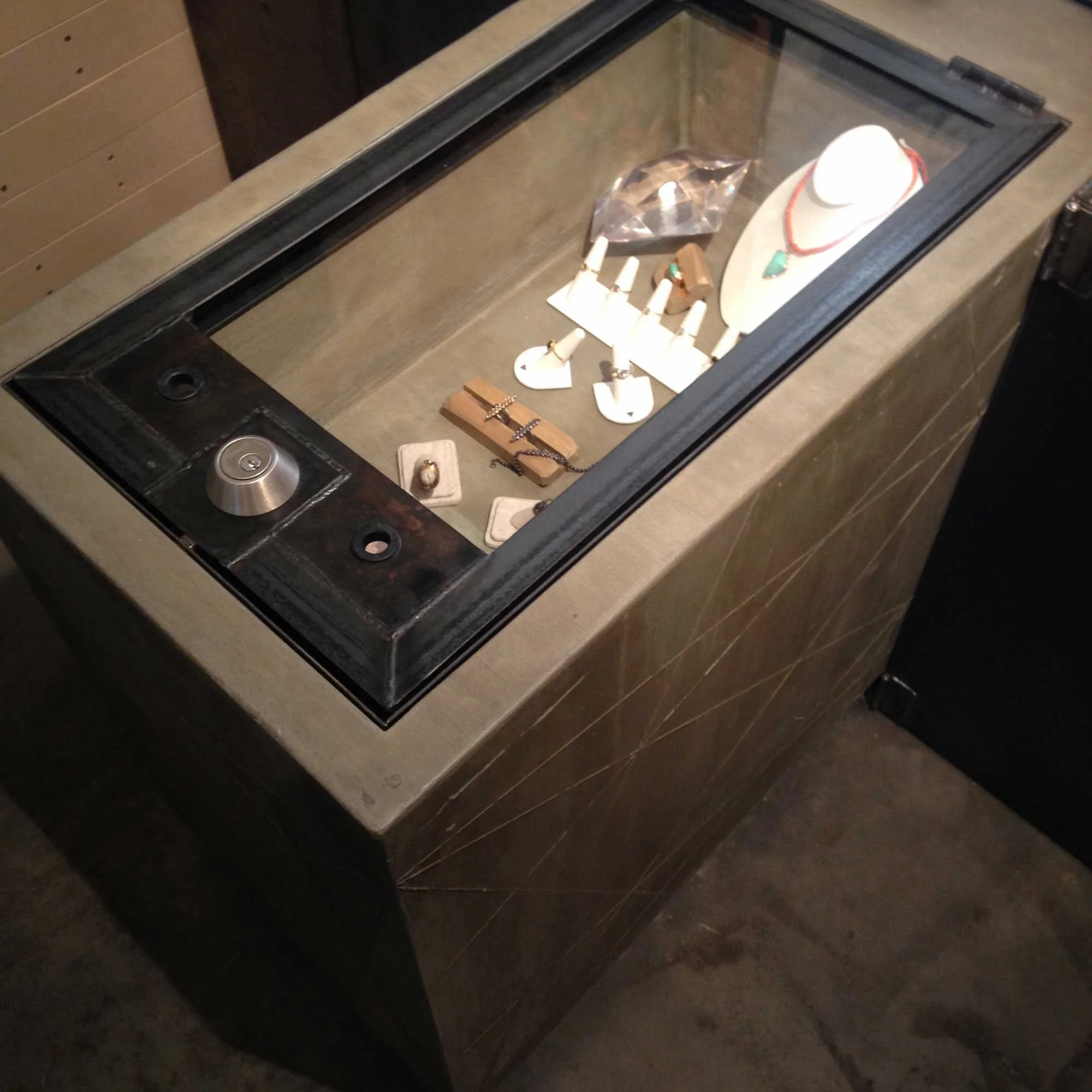 Durable concrete and steel display case for fine jewelry.