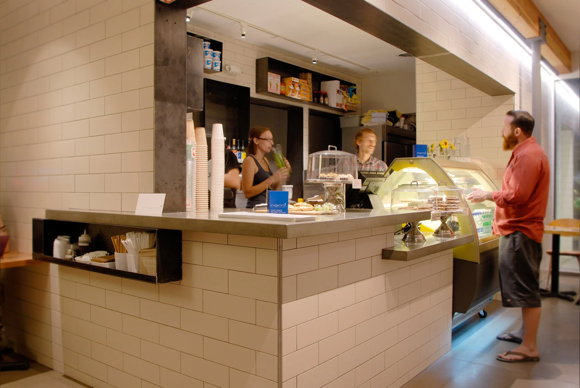 Coffee shop countertops highlighting balance of steel, tile, and concrete