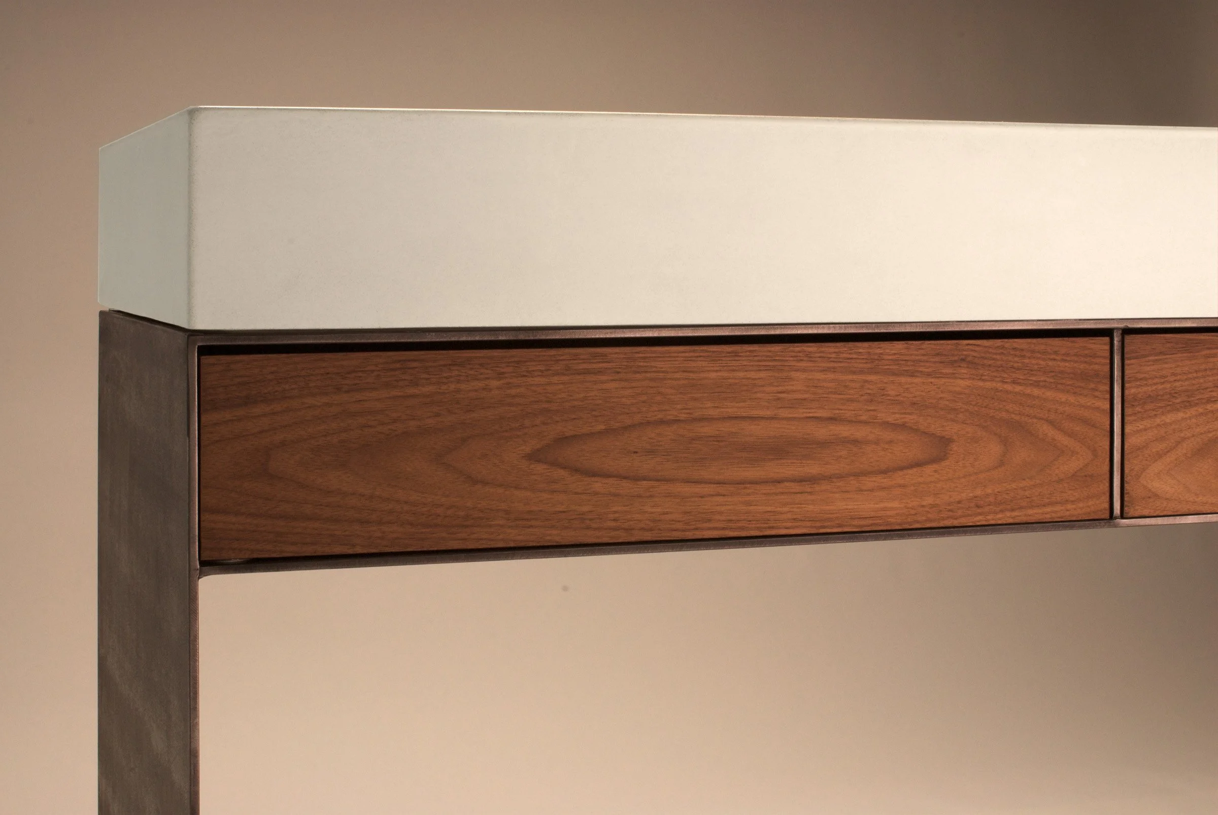 Concrete sink with steel base and rosewood storage drawers for modern interiors.