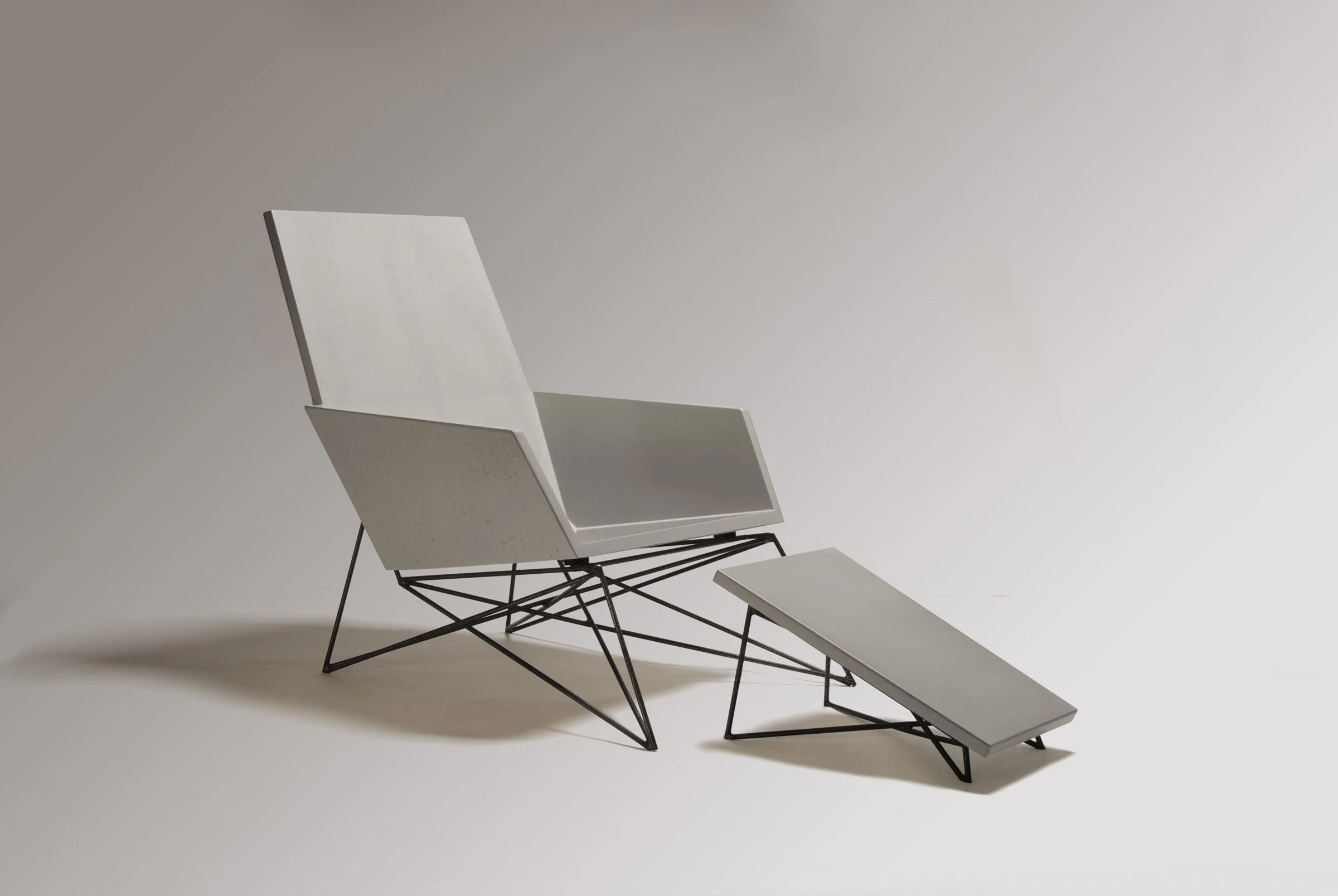 Concrete and steel Muskoka Chair + Ottoman set. Award-winning design, handcrafted in Wichita with GFRC and non-toxic sealer for lasting comfort and durability.