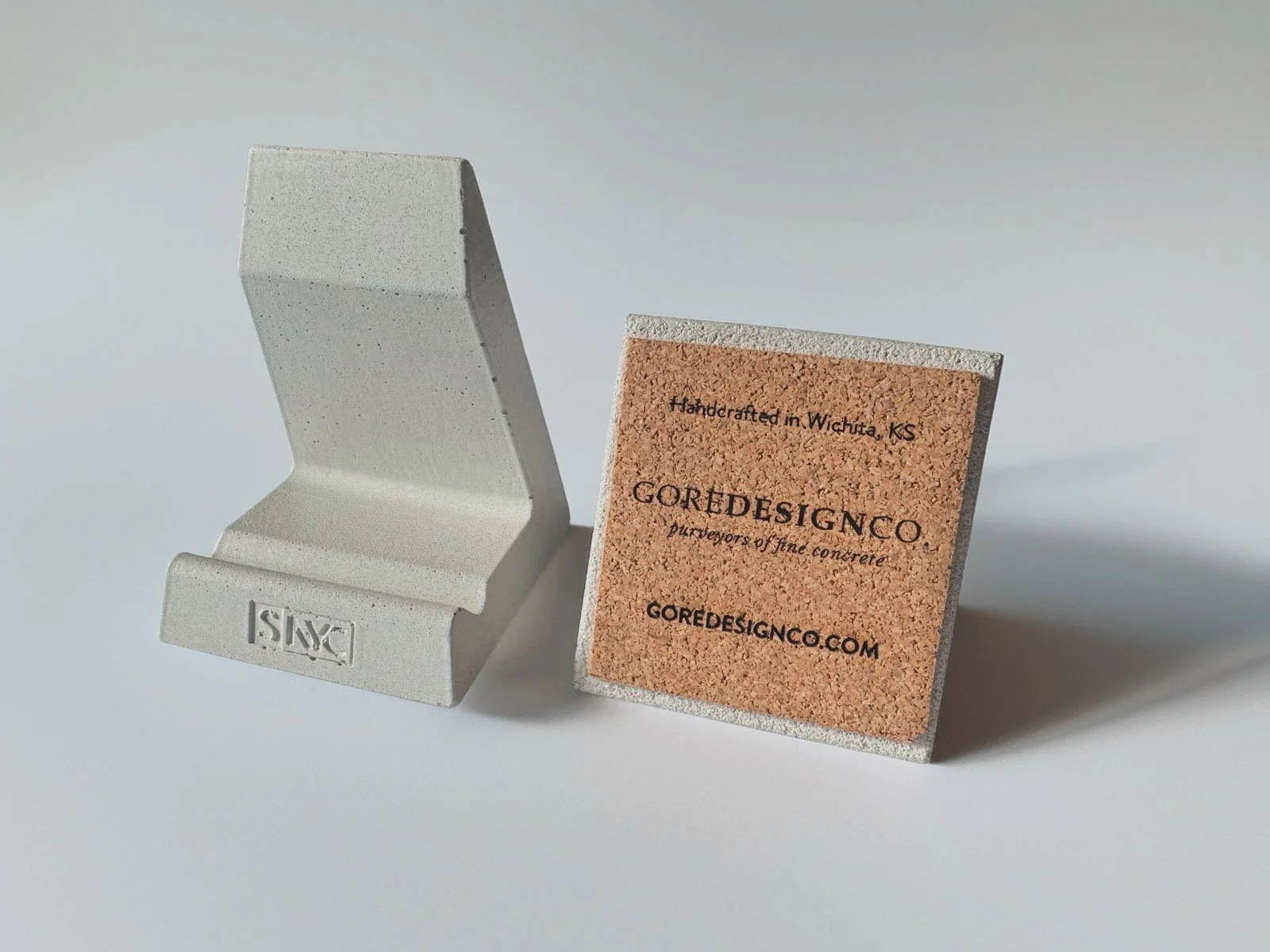 Modern concrete phone holder with cork base for custom corporate gifting