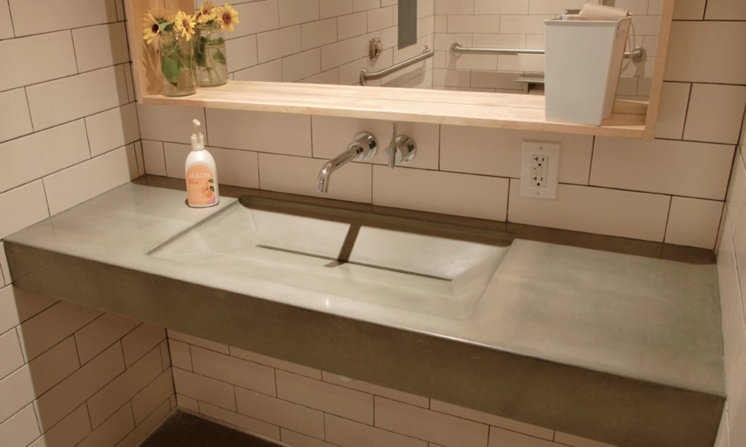 Luxury ramp sink designed for Green in Phoenix. Handcrafted GFRC concrete sink with slot drain, built in the USA for restaurant and hospitality bathrooms.