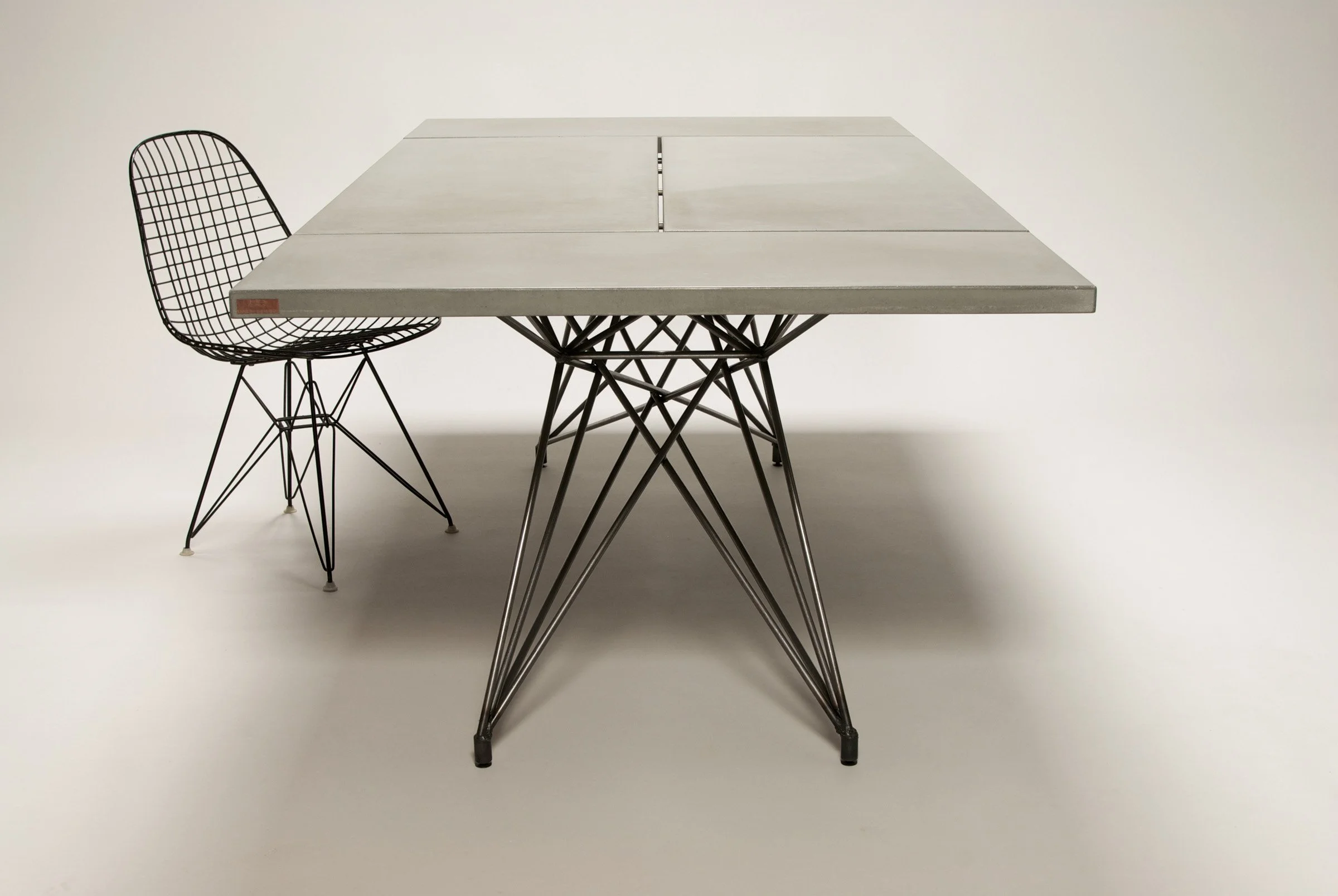 Handcrafted steel base supporting four individual concrete slabs