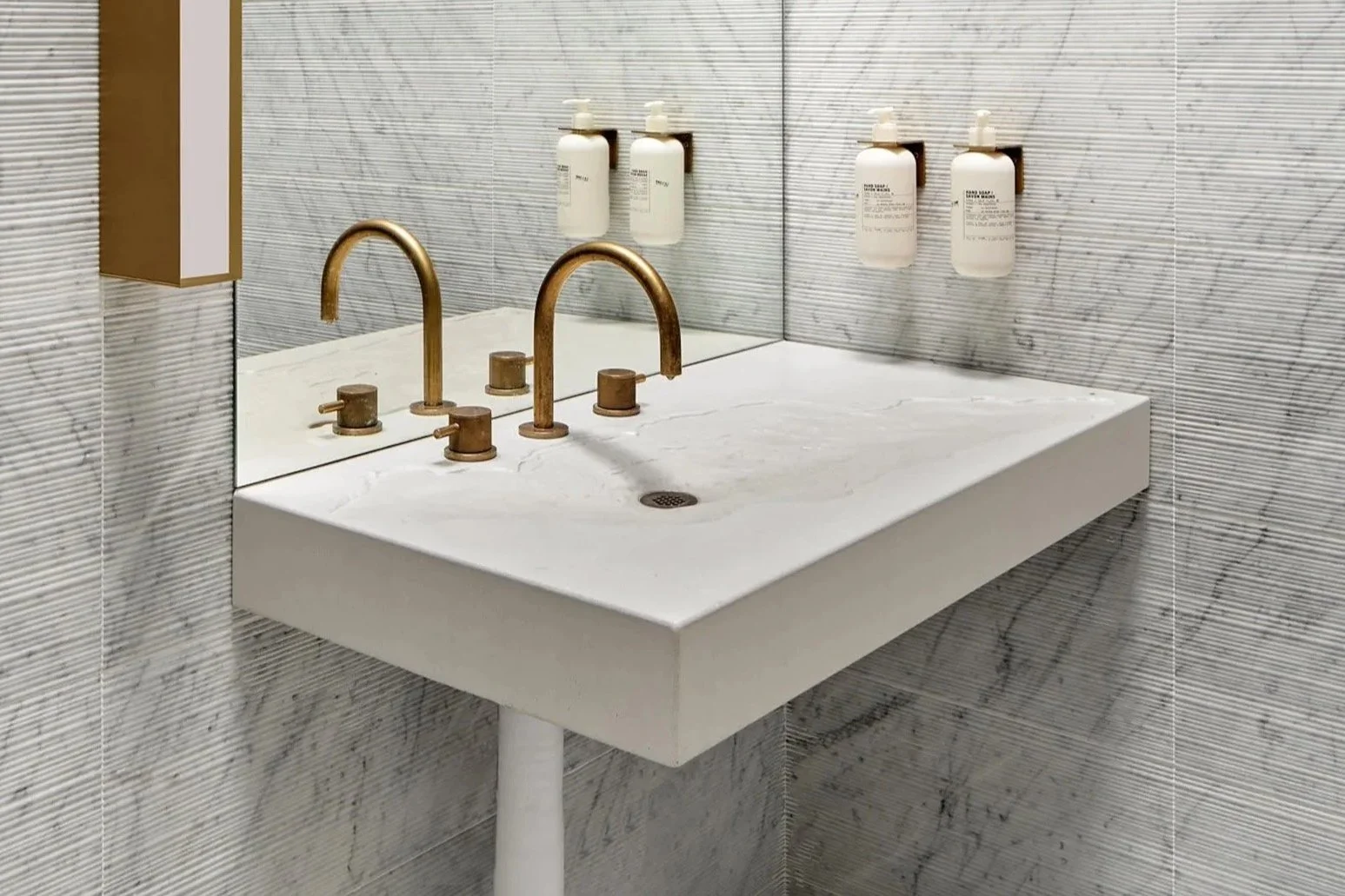Prime Seafood Palace Erosion Sink, custom GFRC concrete bathroom sink with brass pin inlay.