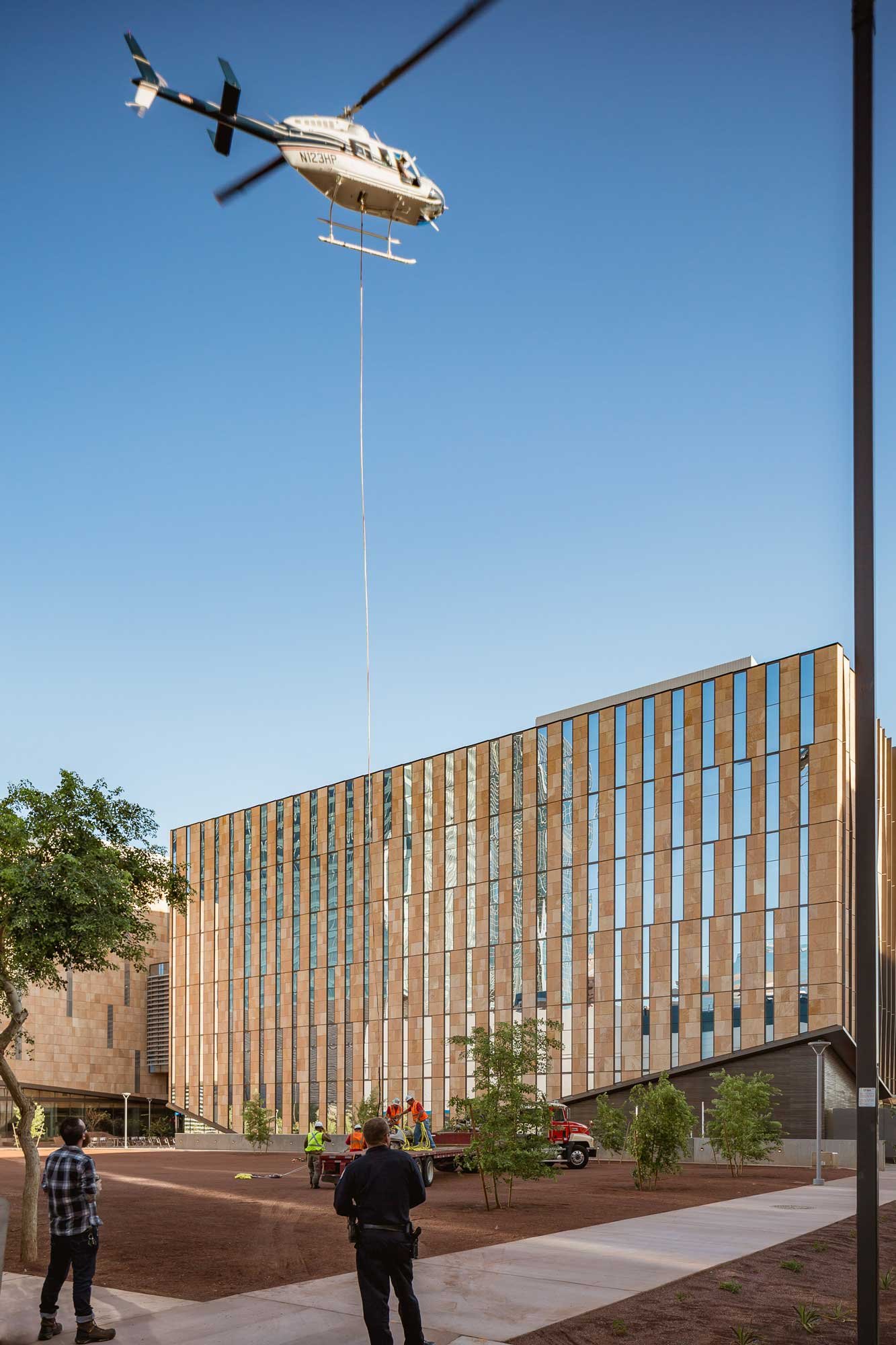 Concrete and steel furniture being lifted by helicopter for rooftop installation