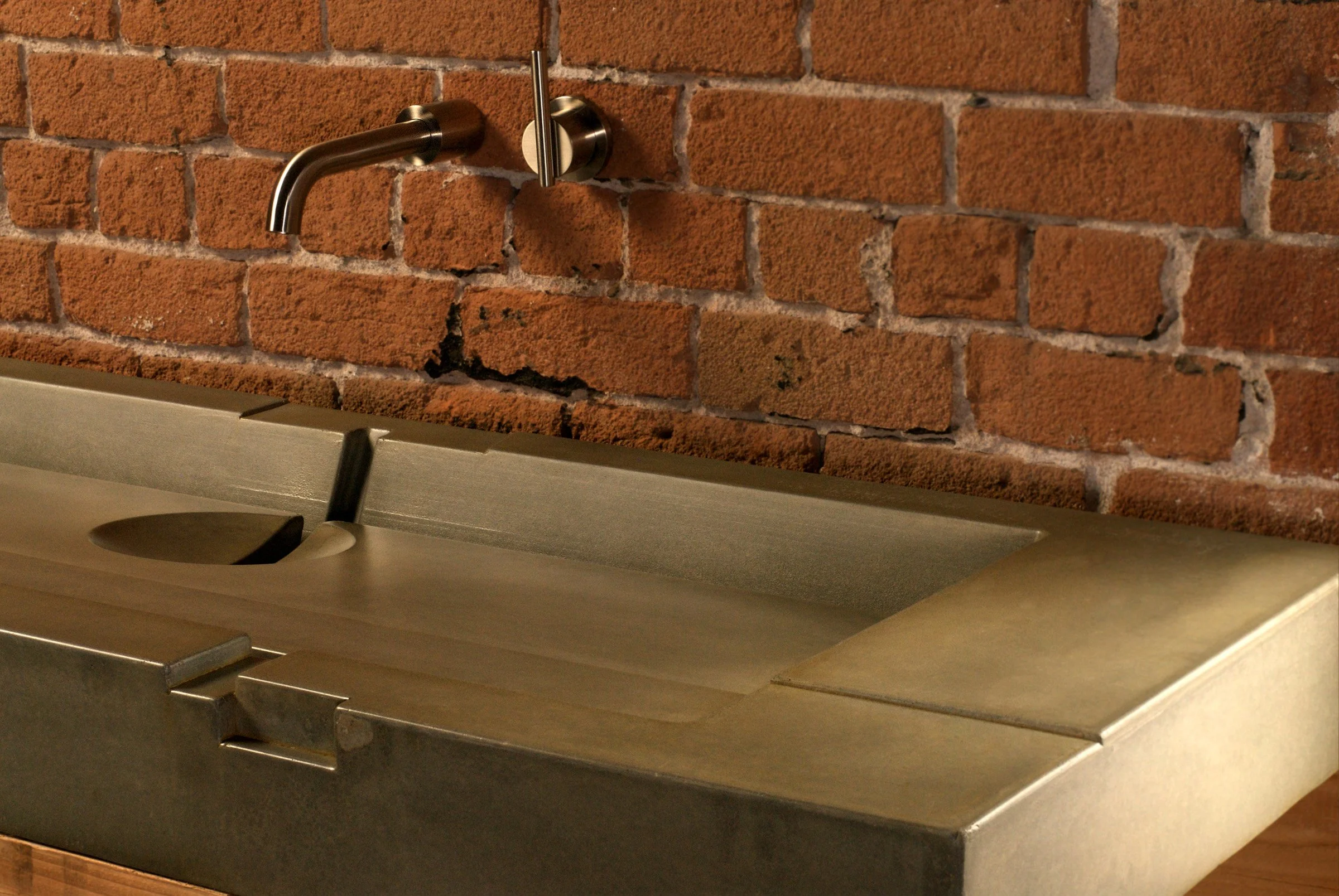 Custom artisan concrete sink with bold geometric design and tea-stain finish. A handcrafted GFRC bathroom sink inspired by ancient architecture and modern craft.