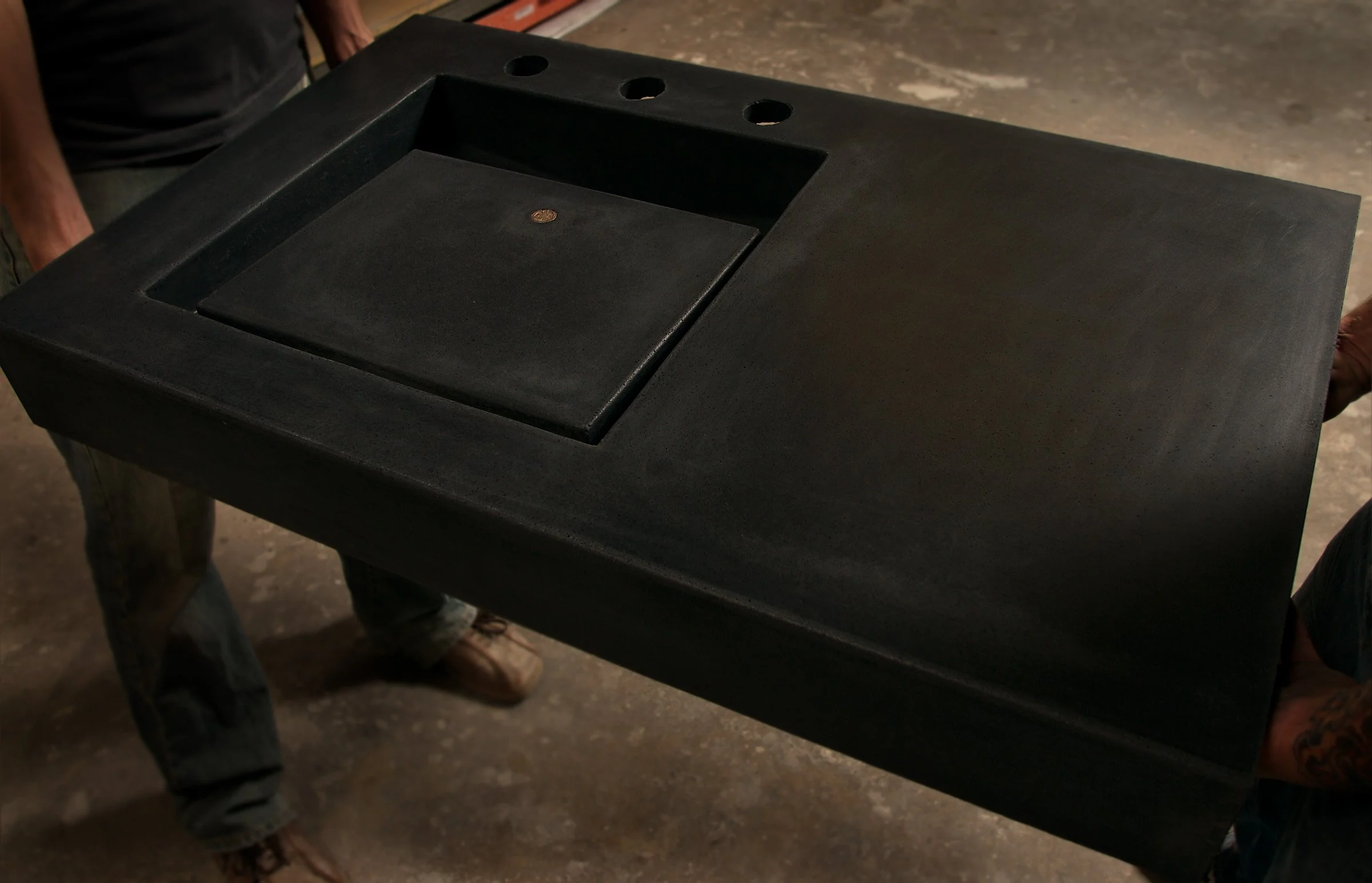 Custom artisan bathroom sink with early geometric design. Crafted from UHPC concrete and sealed with non-toxic, isocyanate-free finish for safe, healthy spaces.