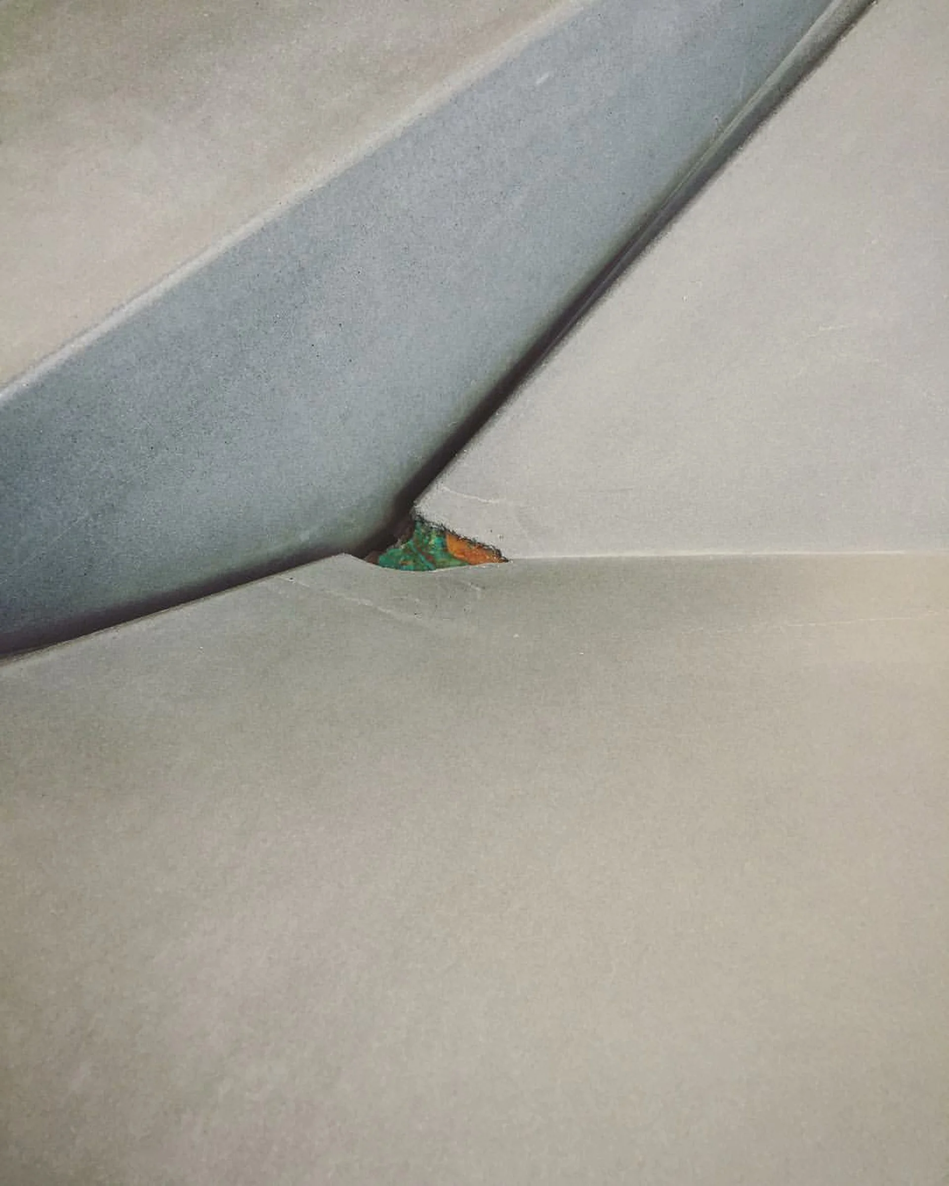 Handcrafted erosion-style concrete sink with turquoise inlay detail. Made in the USA using crystalline silica-free GFRC concrete for luxury residential bathrooms.