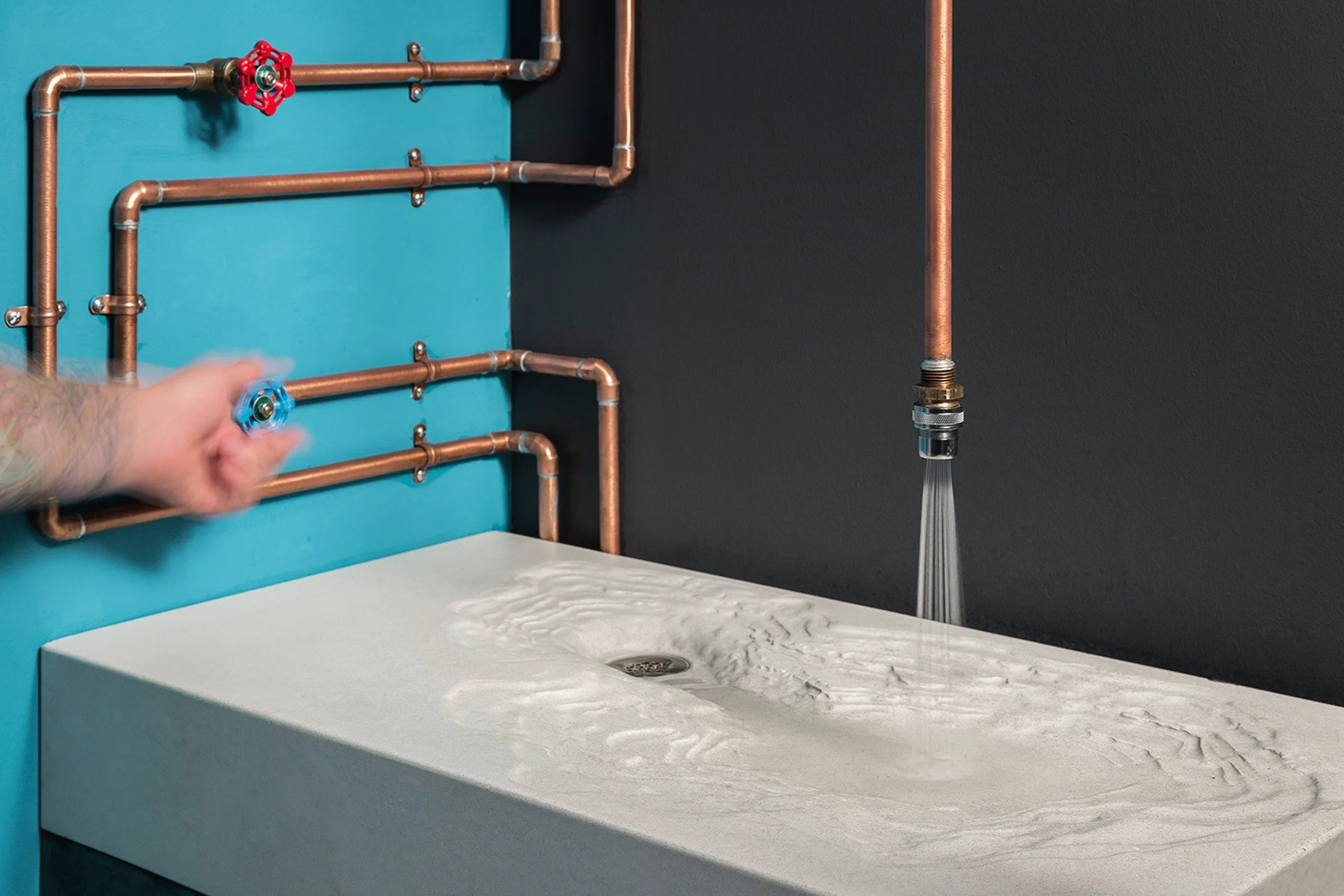 Golden Rule Erosion Sink in bone concrete, custom sink crafted for a Phoenix tattoo shop.