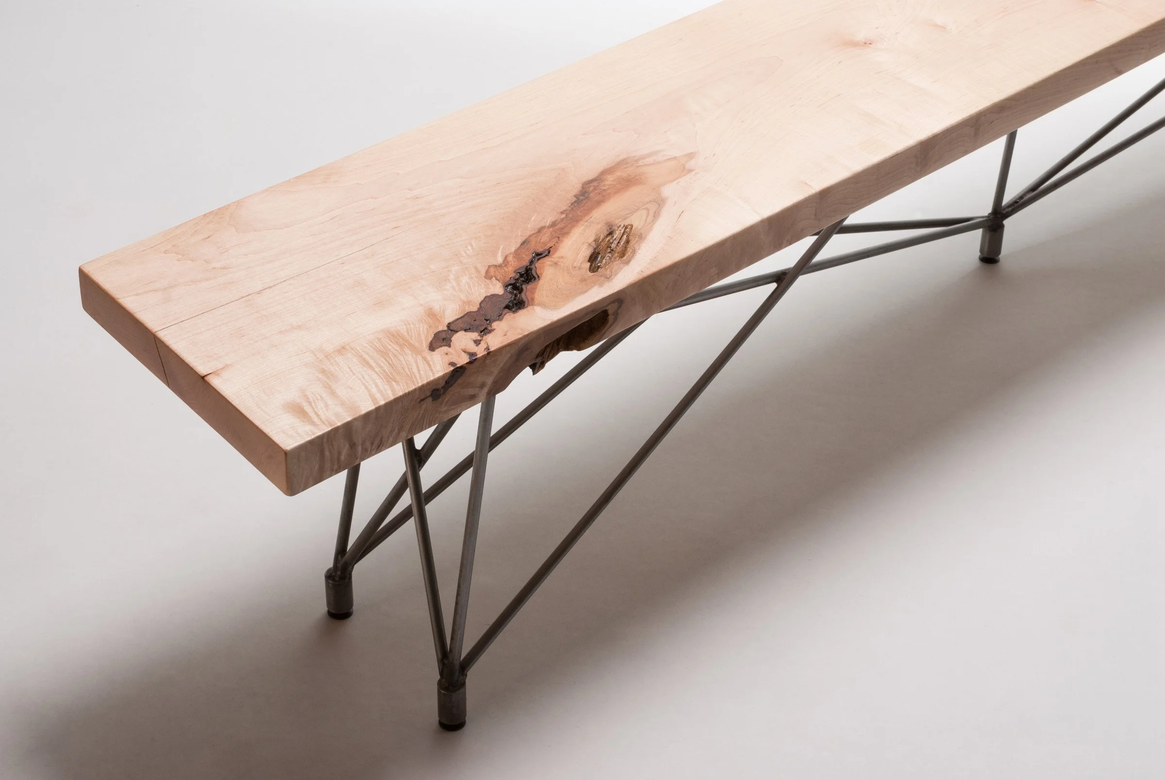Custom wood and steel benches designed to accompany a mid-century modern concrete dining table