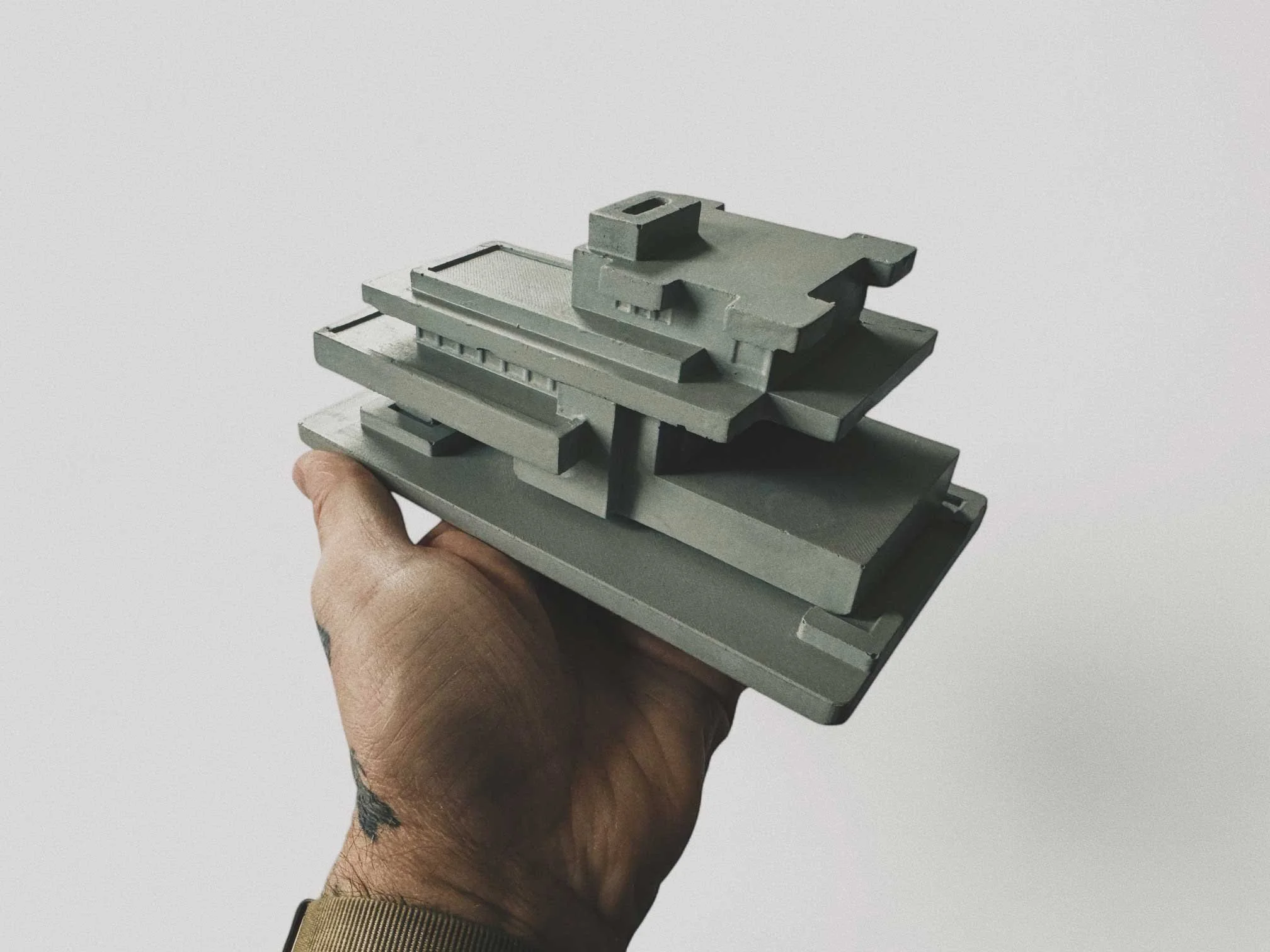 Frank Lloyd Wright-inspired concrete incense holder with architectural geometry