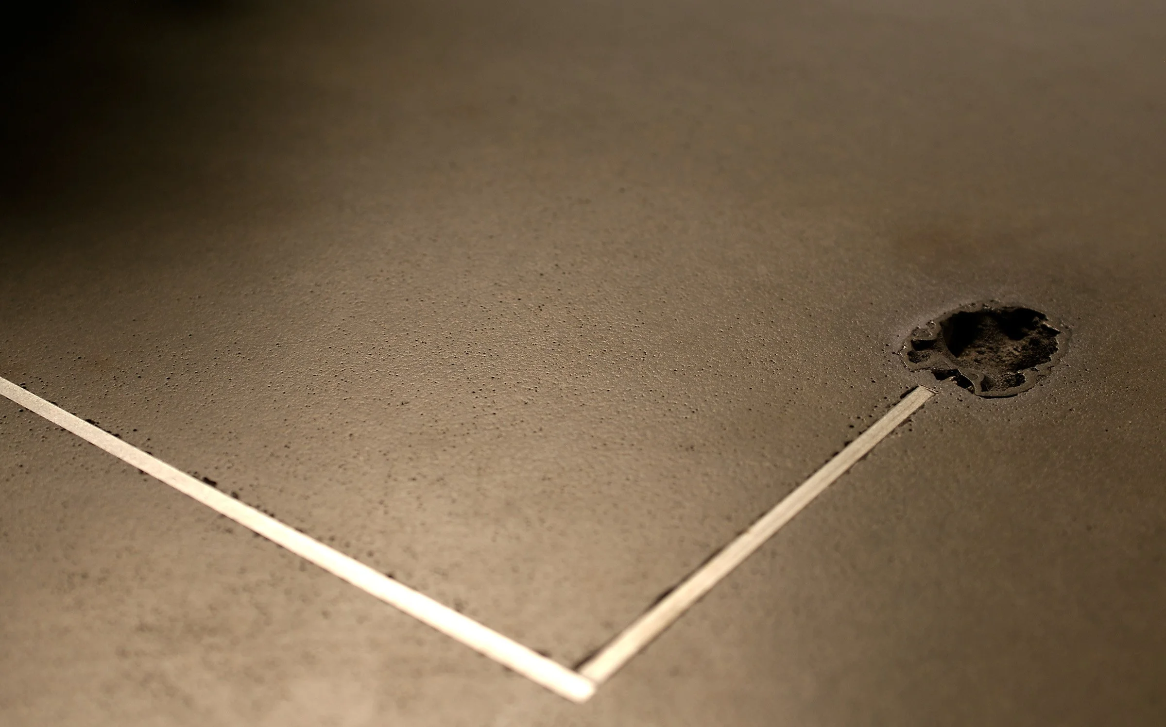 Stainless steel and fossil inlay in GFRC concrete table top