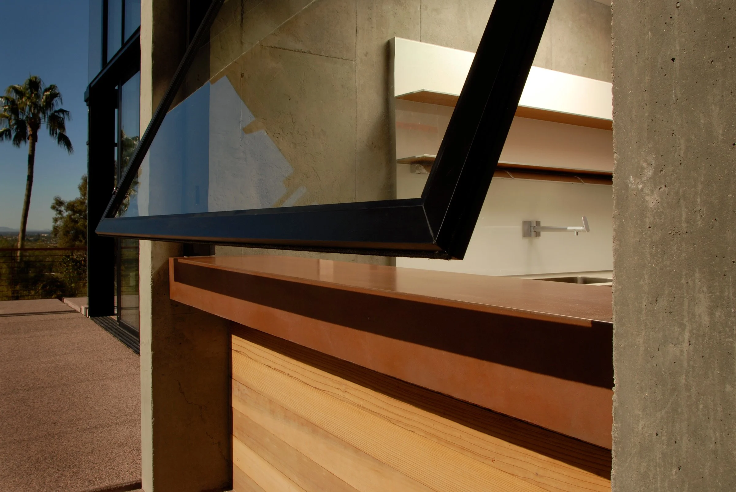 Handcrafted Cherokee Red concrete countertop inspired by Frank Lloyd Wright. Designed as a window sill and countertop surface, built for a Camelback Mountain residence.
