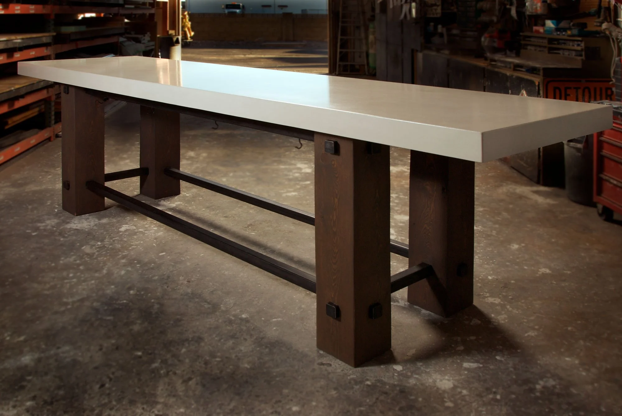 Two handcrafted communal dining tables for Tarbell’s in Centennial, CO. Smooth white concrete with rough wood bases and steel supports for warmth and durability.