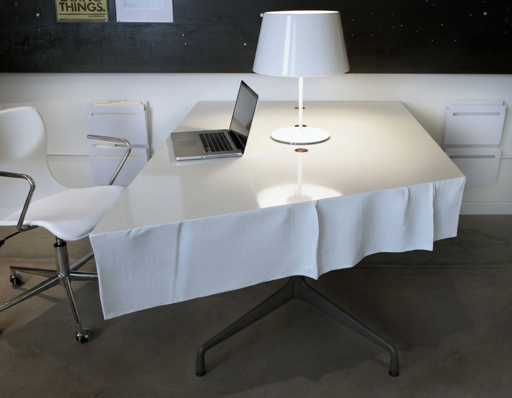 Custom fabric-formed concrete desk for Gore Design Co. studio in Tempe, AZ. Bone UHPC GFRC, copper cord grommets, and Eames Aluminum Group base.