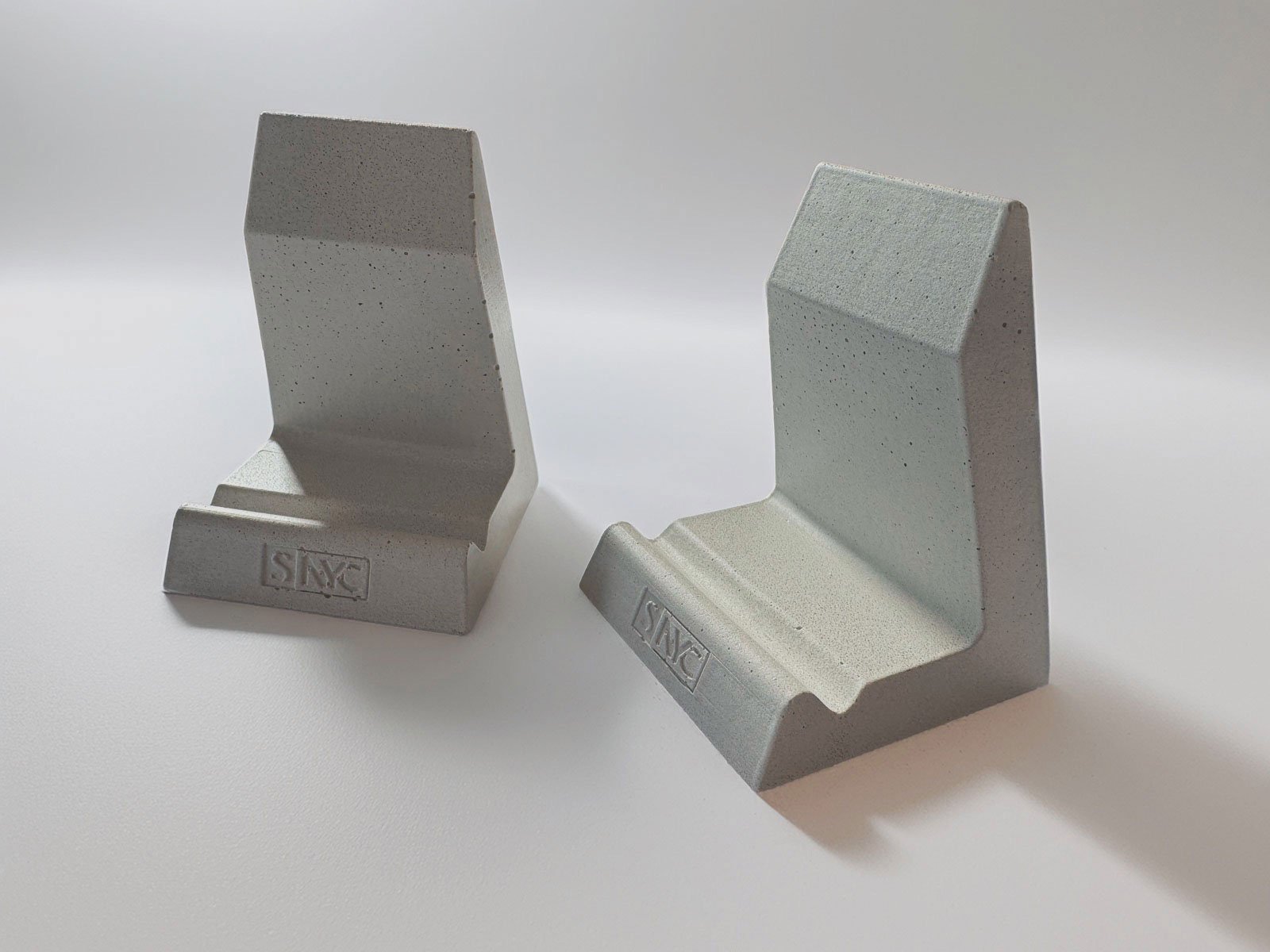 Custom concrete phone stand designed as a corporate gift for construction clients