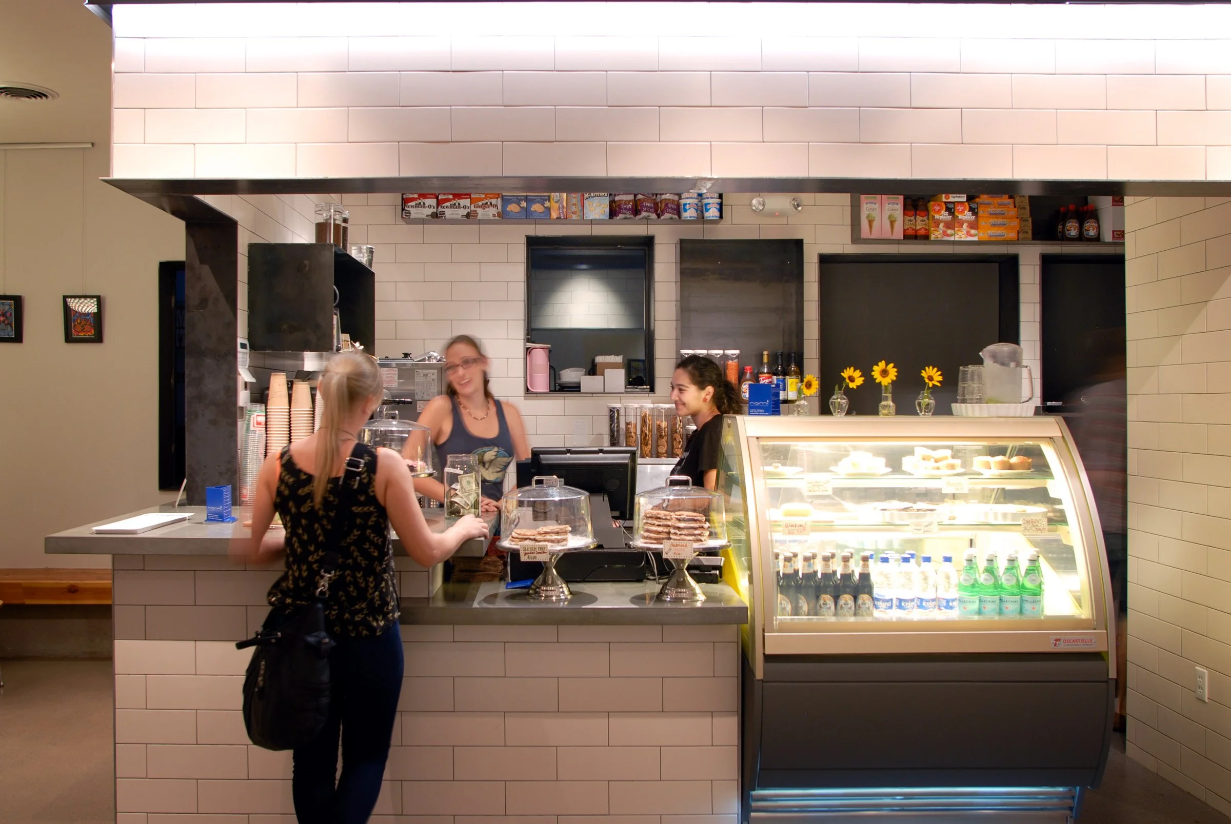 Handcrafted café countertops balancing white subway tile and blackened steel