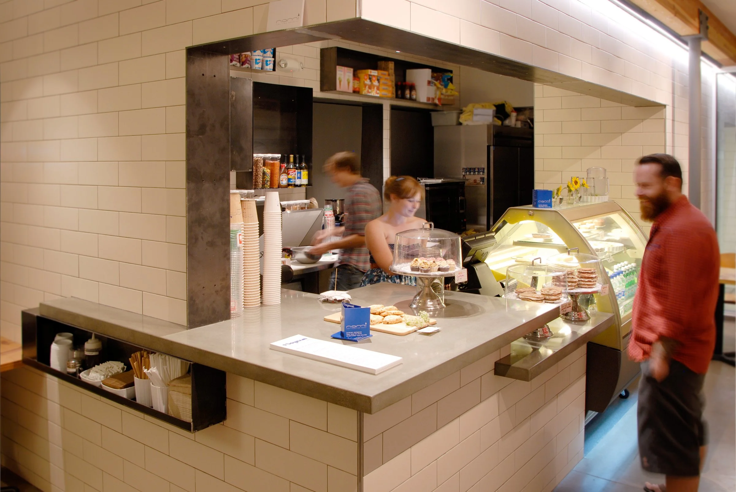 Custom concrete café countertops built for NAMI, Phoenix. Handcrafted in Wichita with healthy, non-toxic finishes that bring warmth and durability to commercial spaces.
