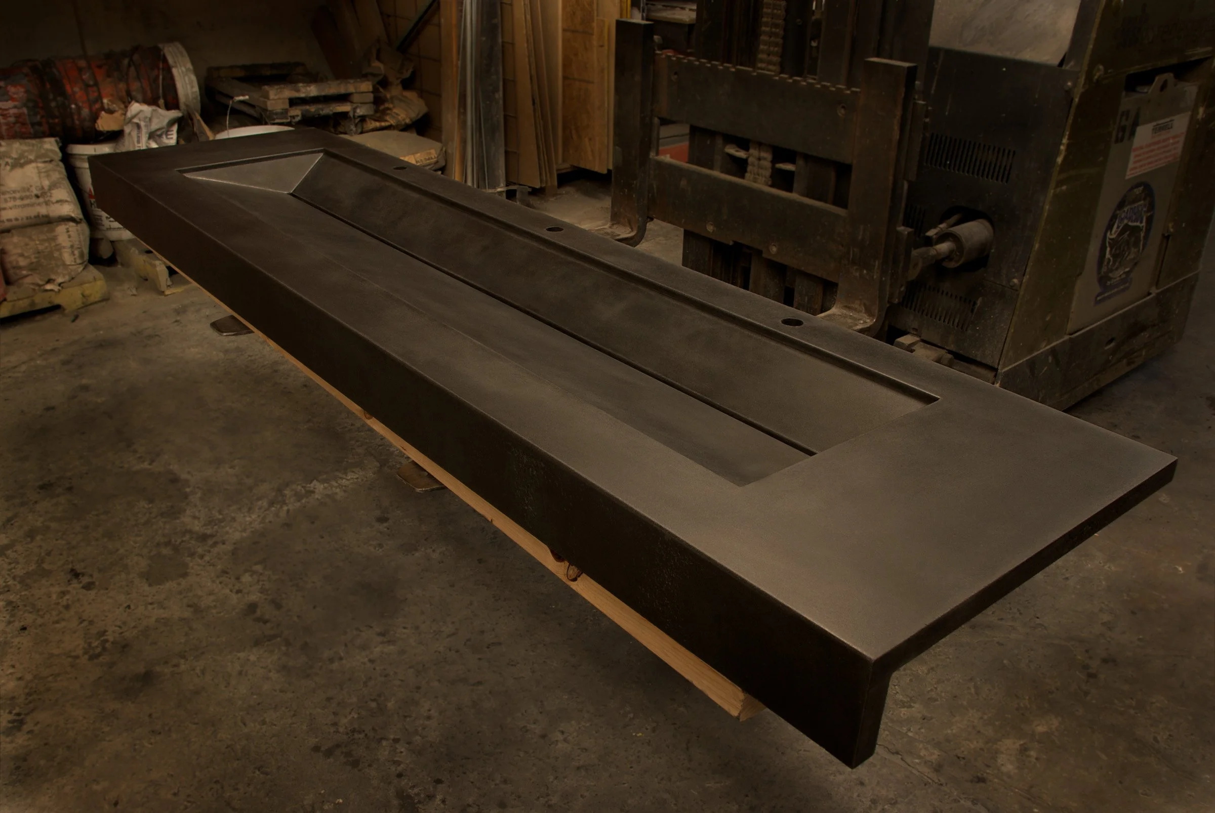 Handcrafted concrete sink with slot drain engineered for high-capacity bathrooms.