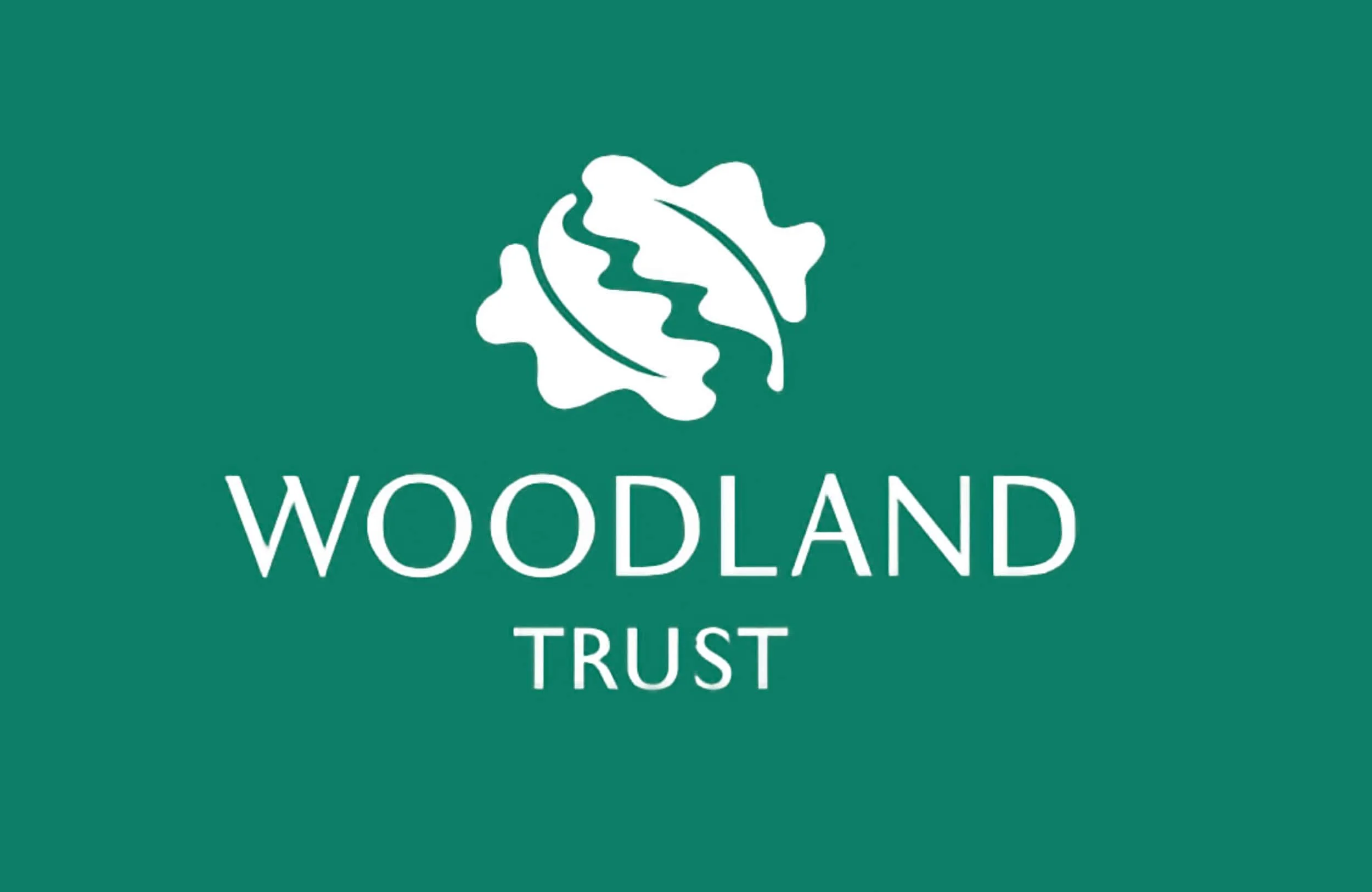 Logo of Woodland Trust featuring an abstract oak leaf and text 'Woodland Trust' on a green background.