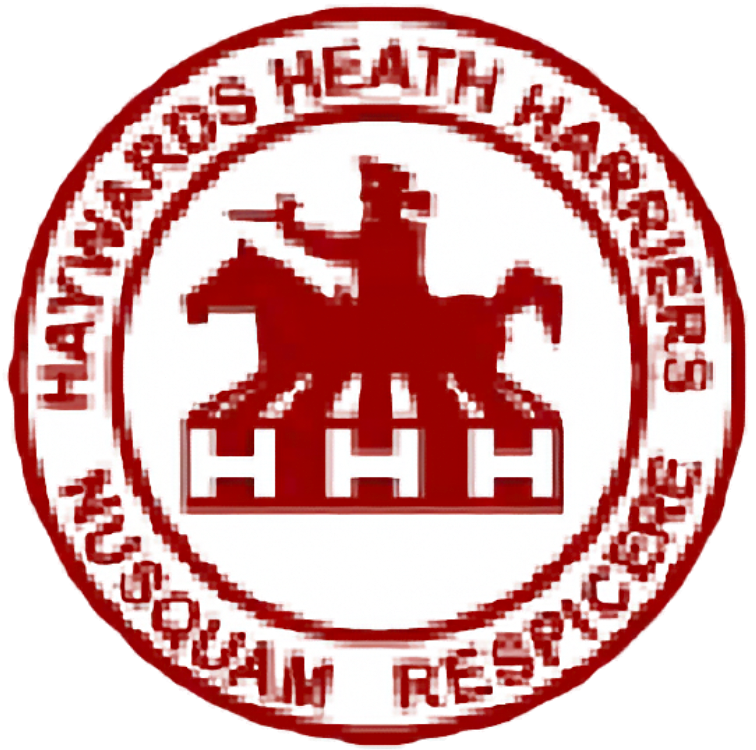 Group of runners at the beach participating in a race, wearing matching red and black athletic outfits with race bibs, under a cloudy sky, with the text 'Haywards Heath Harriers' and a logo in the top left corner.