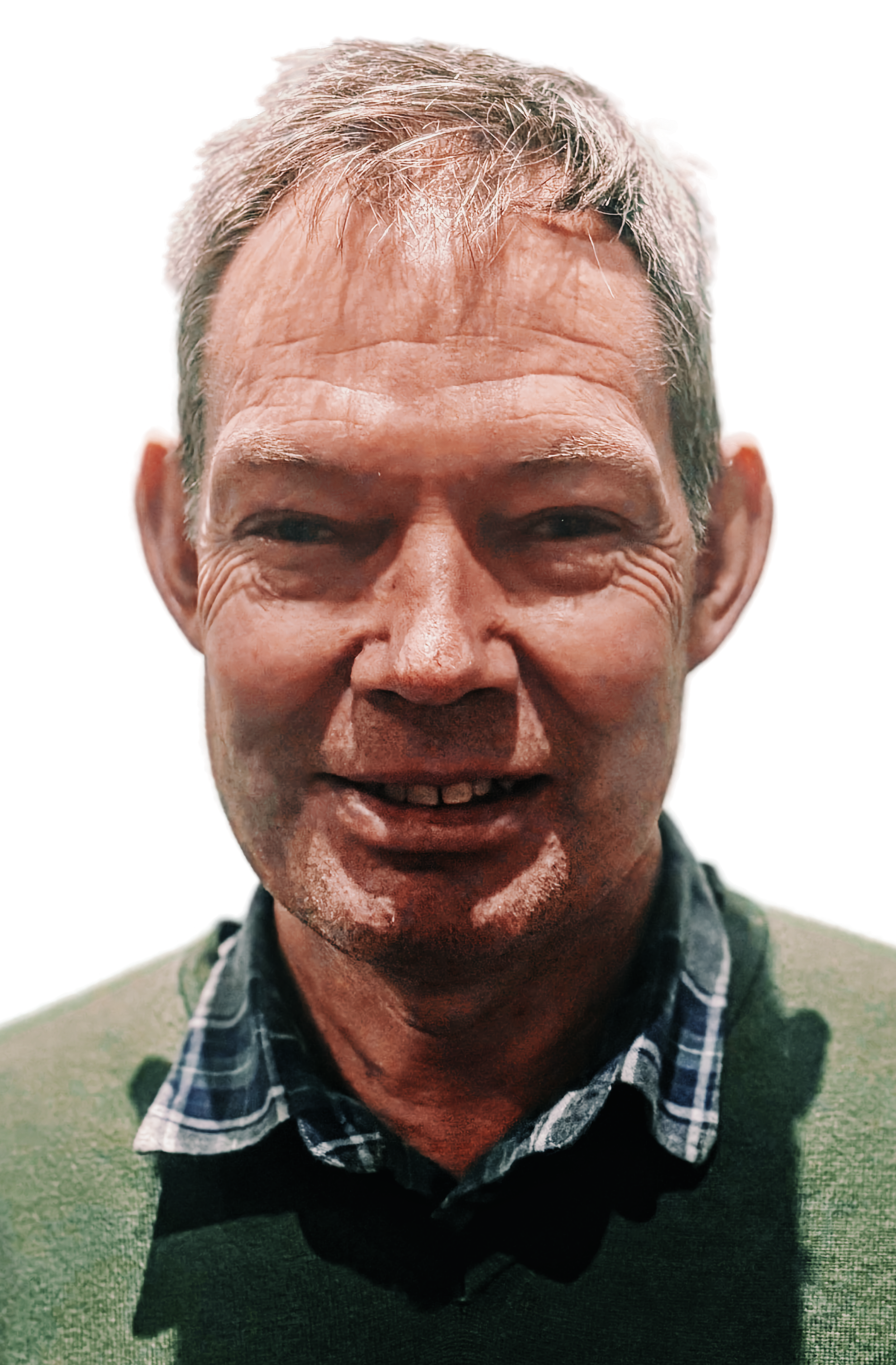 Smiling middle-aged man with gray hair, wearing a green sweater over a plaid shirt, against a colorful background.