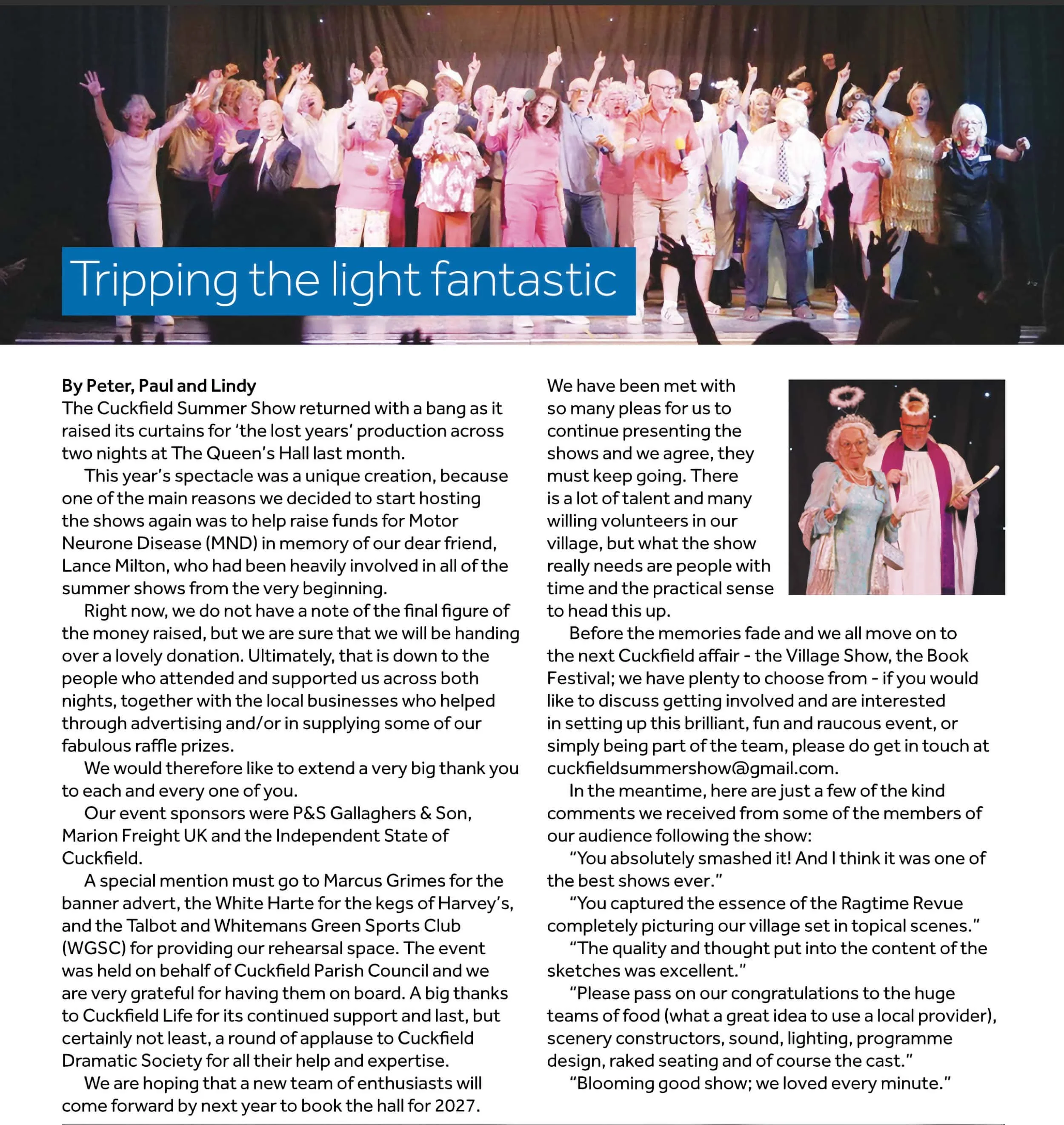 A group of performers on stage singing and dancing, with some raising their hands, during a summer show event.