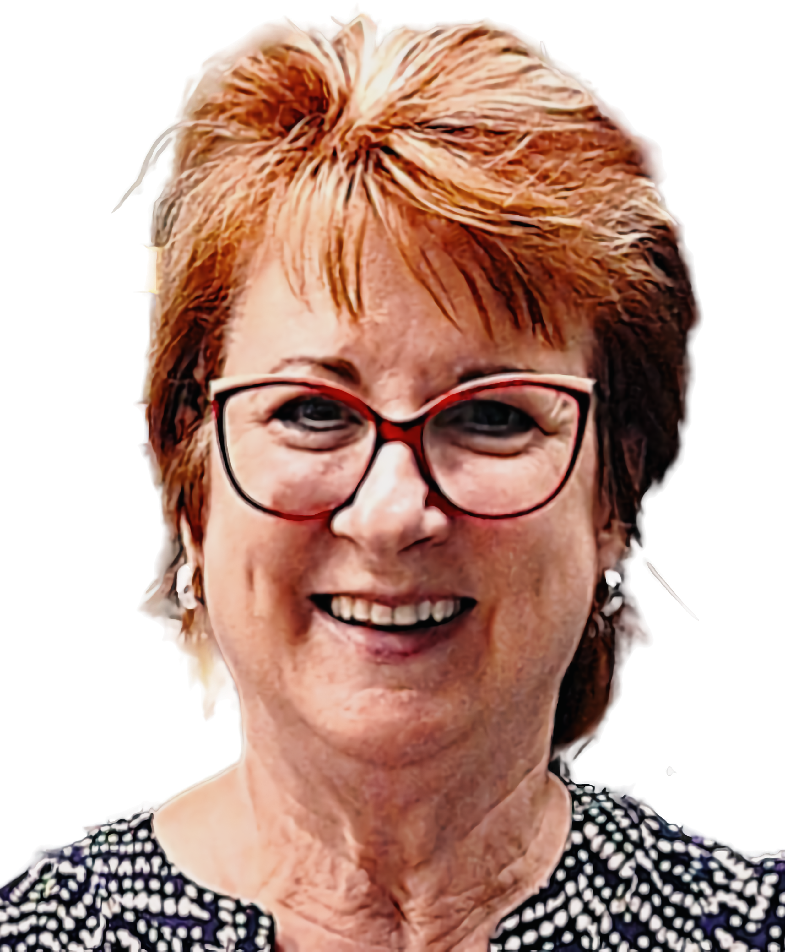 A smiling woman with short, reddish hair and red-framed glasses.