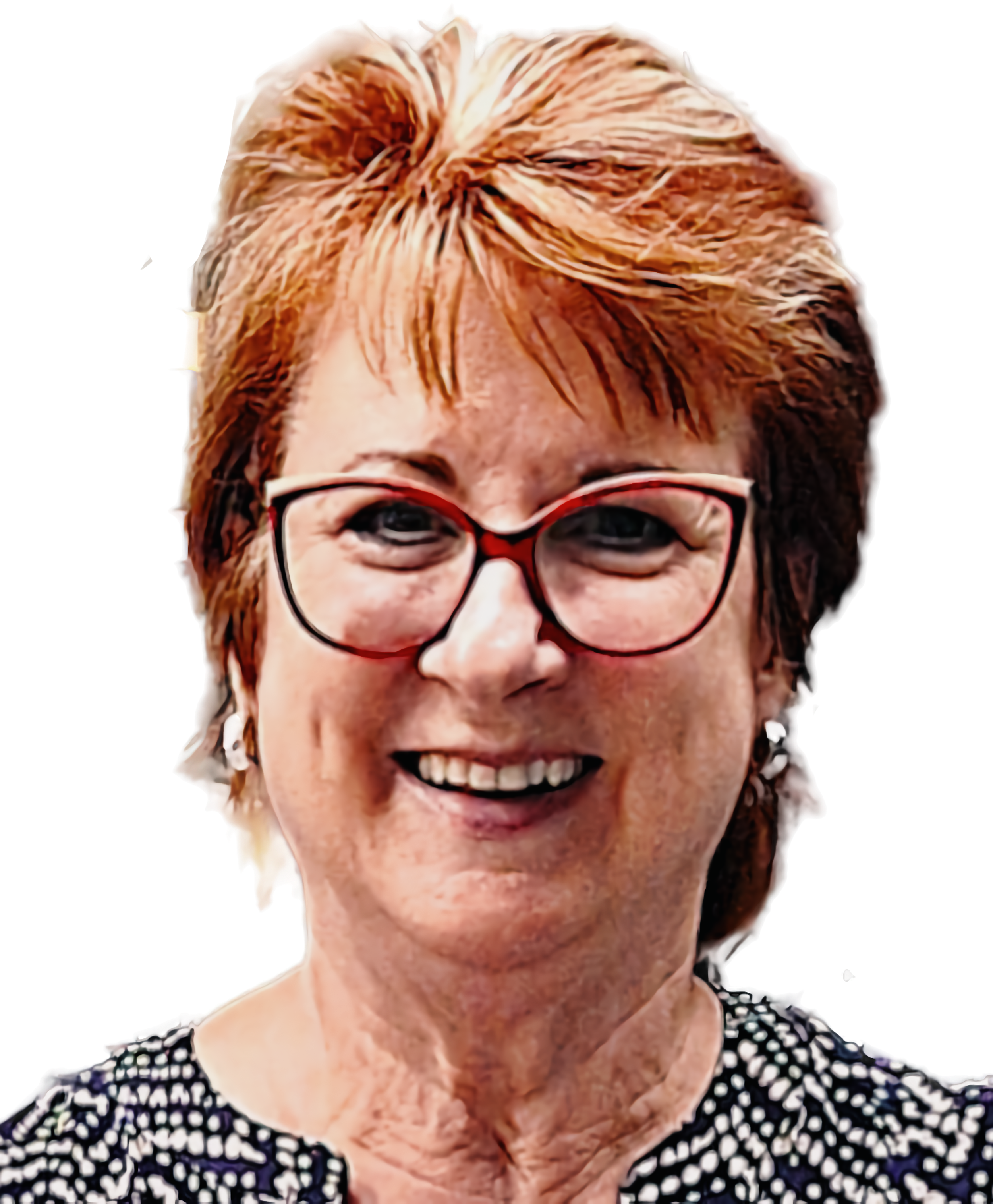 A smiling woman with short, reddish hair, wearing red and black glasses, and a patterned black and white top.