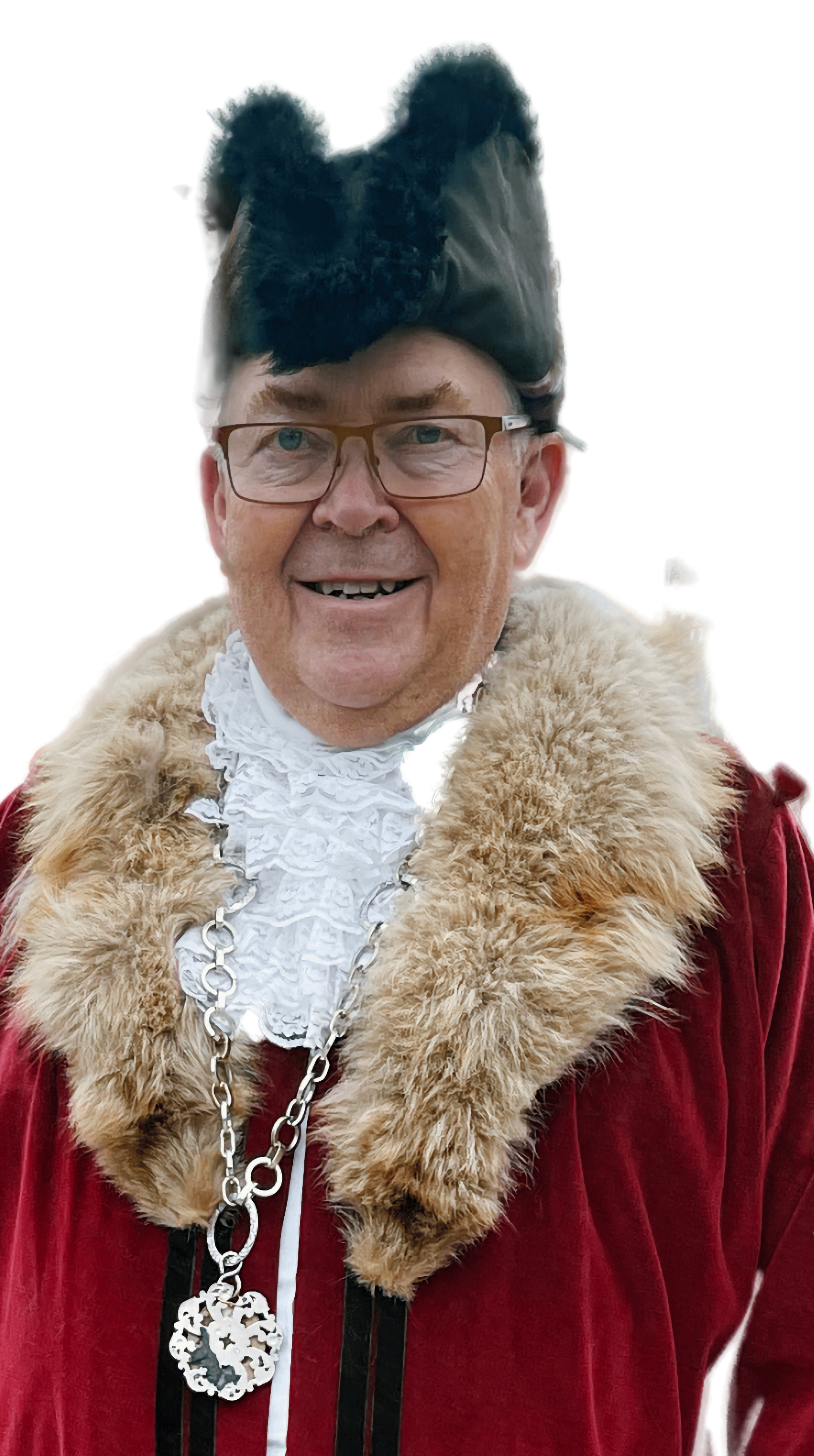 Man dressed in historical royal attire with a large fur collar, wearing a black fur hat, glasses, and a silver chain necklace, smiling.