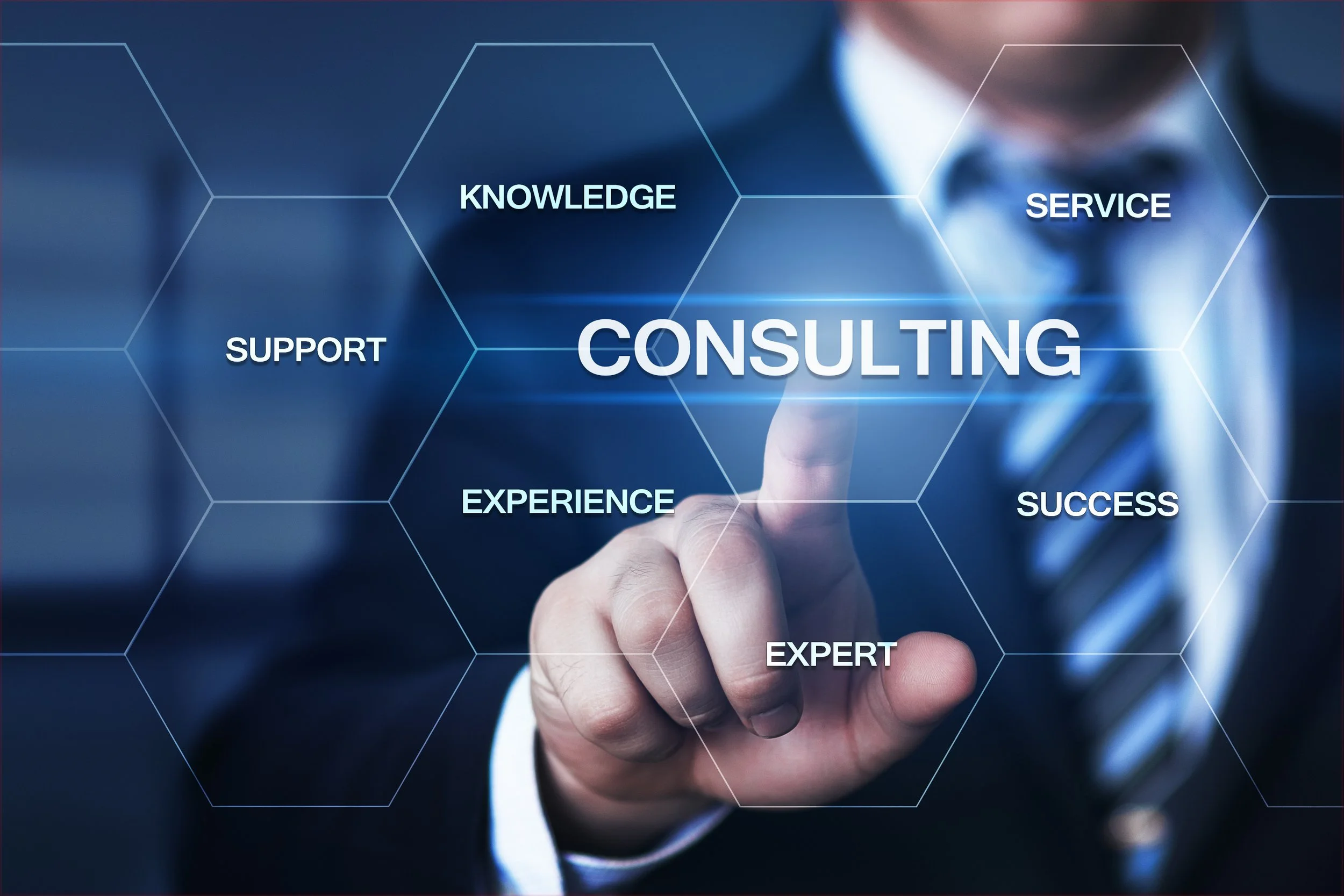 Business professional in suit and tie pointing at a virtual screen with the word 'Consulting' in the center, surrounded by related words like support, knowledge, service, experience, success, and expert.