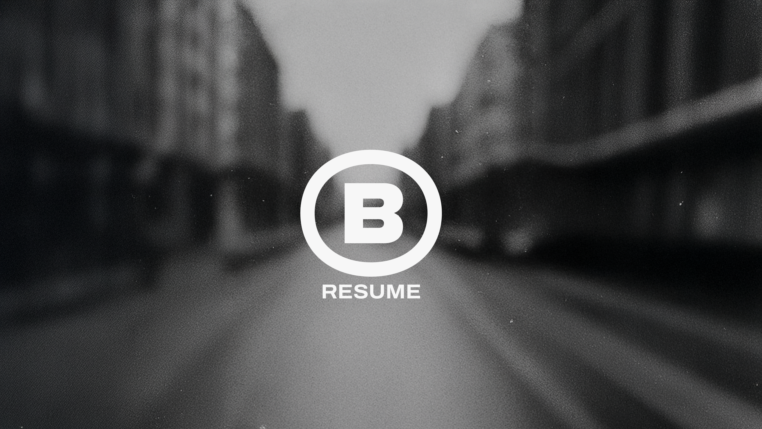 BOBB logo over a blurred black and white city street, symbolizing movement and creative direction by Brian Bobb.