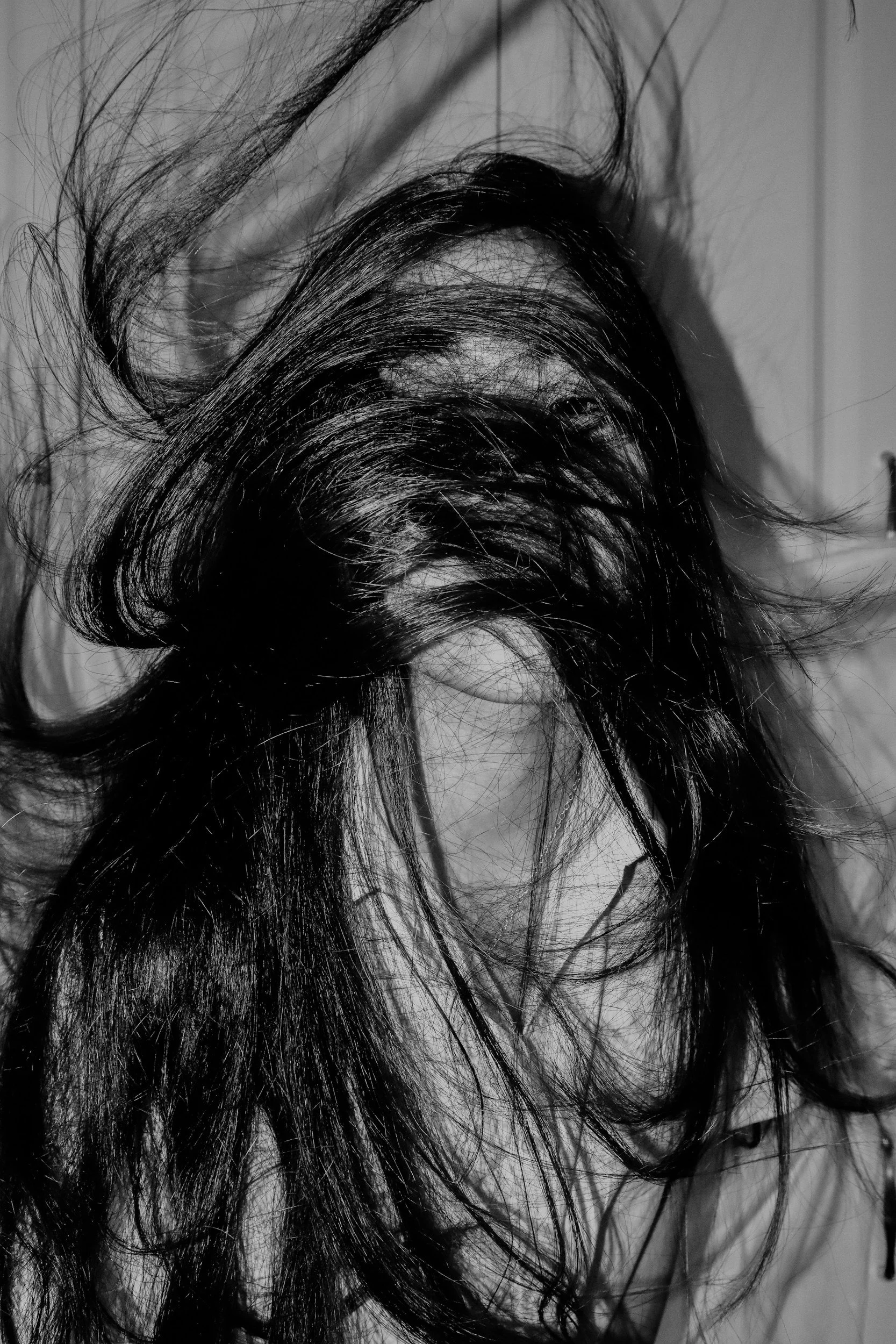 Disheveled hair on a person's head, black and white photograph.