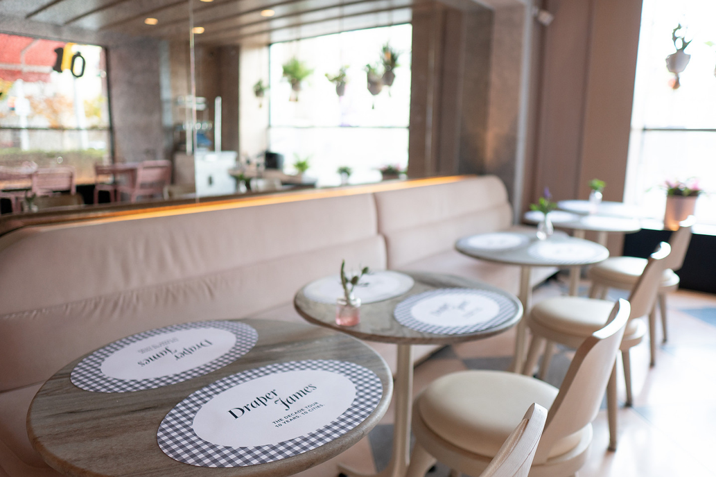 Pink benches, gingham placemats, and custom vinyls in the background set the scene