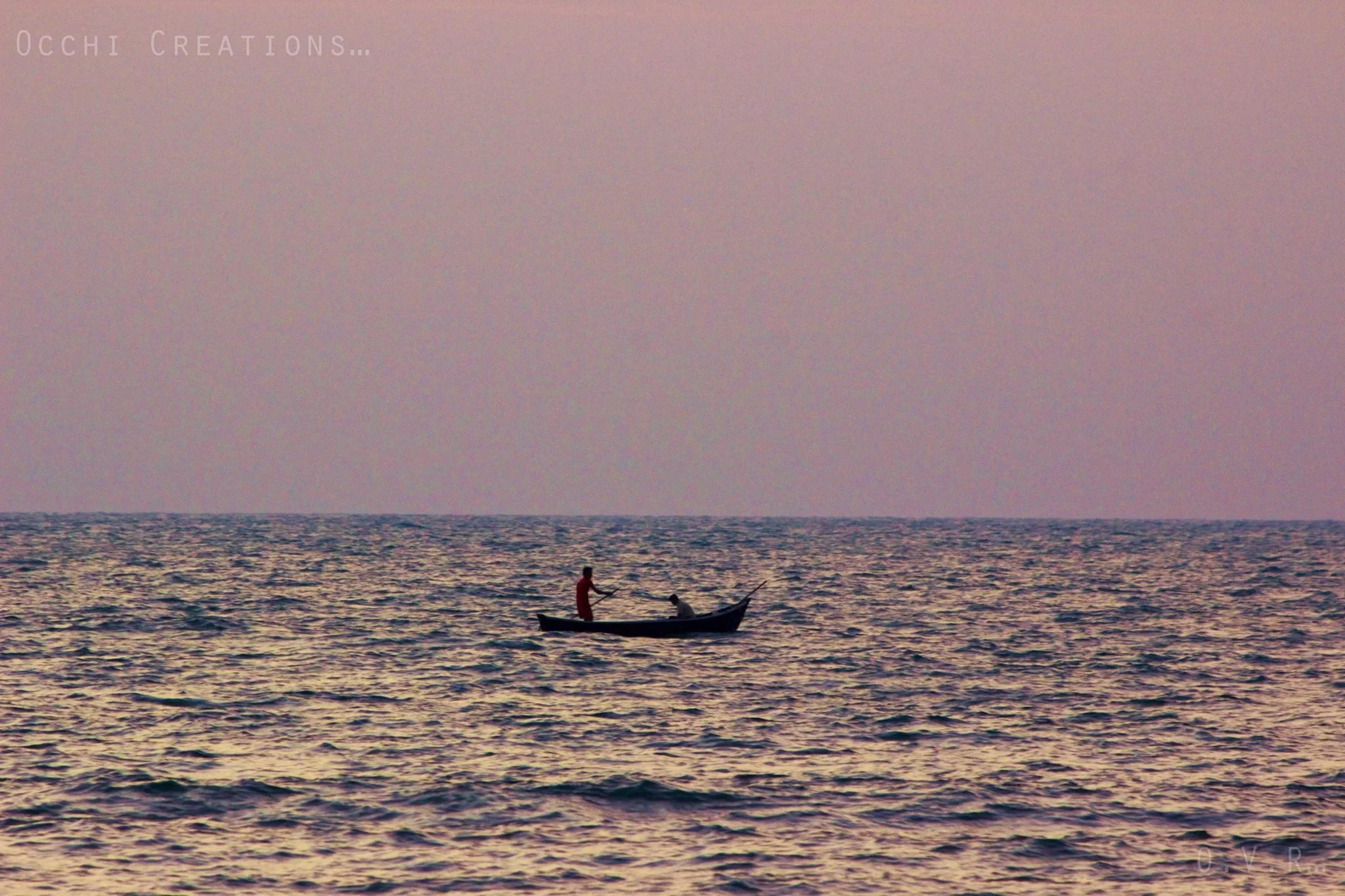 A boat with two people on the water during sunset.