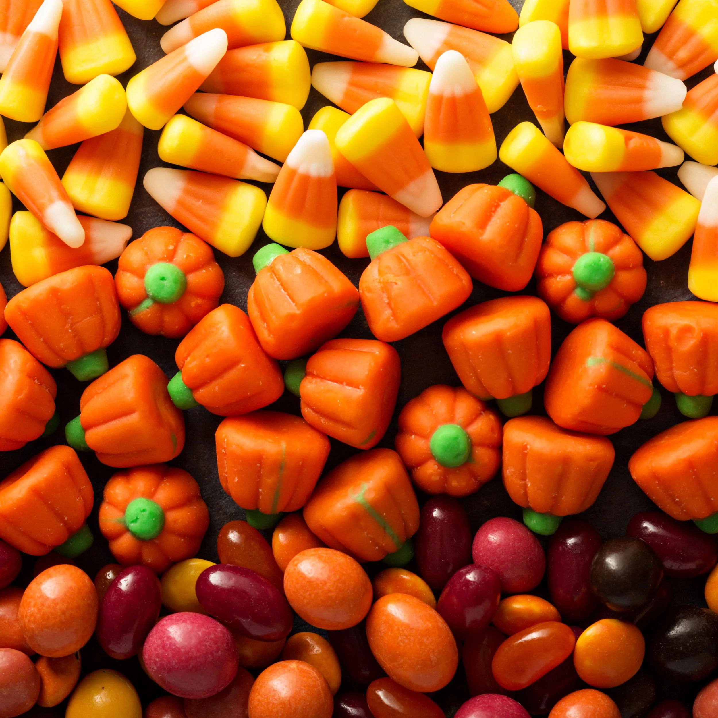 vecteezy_candy-corn-and-pumpkin-halloween-background_15758981.jpg