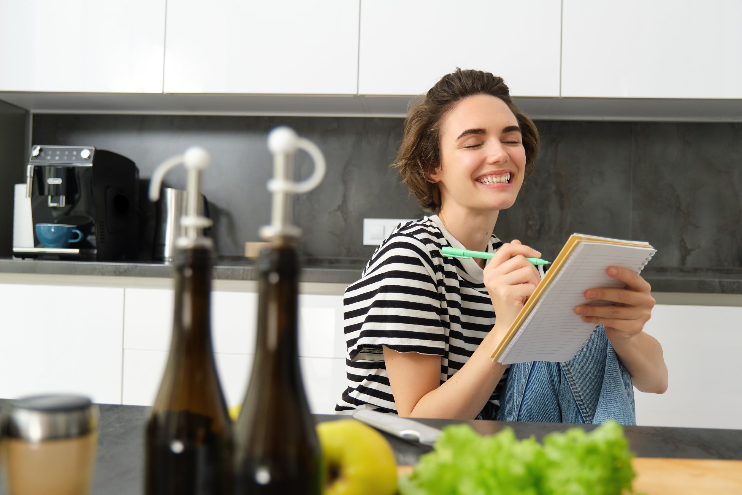 vecteezy_close-up-of-happy-smiling-young-woman-writing-in-notebook_35807157.jpg