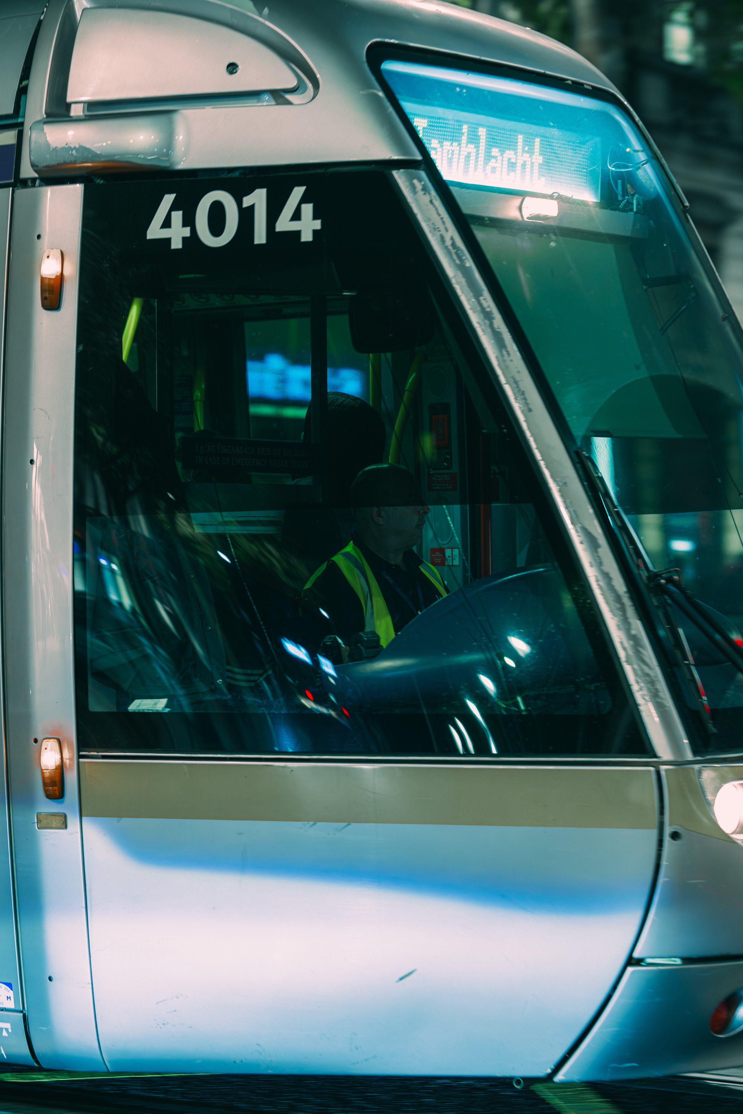Close-up of a modern tram with the number 4014 on the front, and a digital display showing an unreadable message.