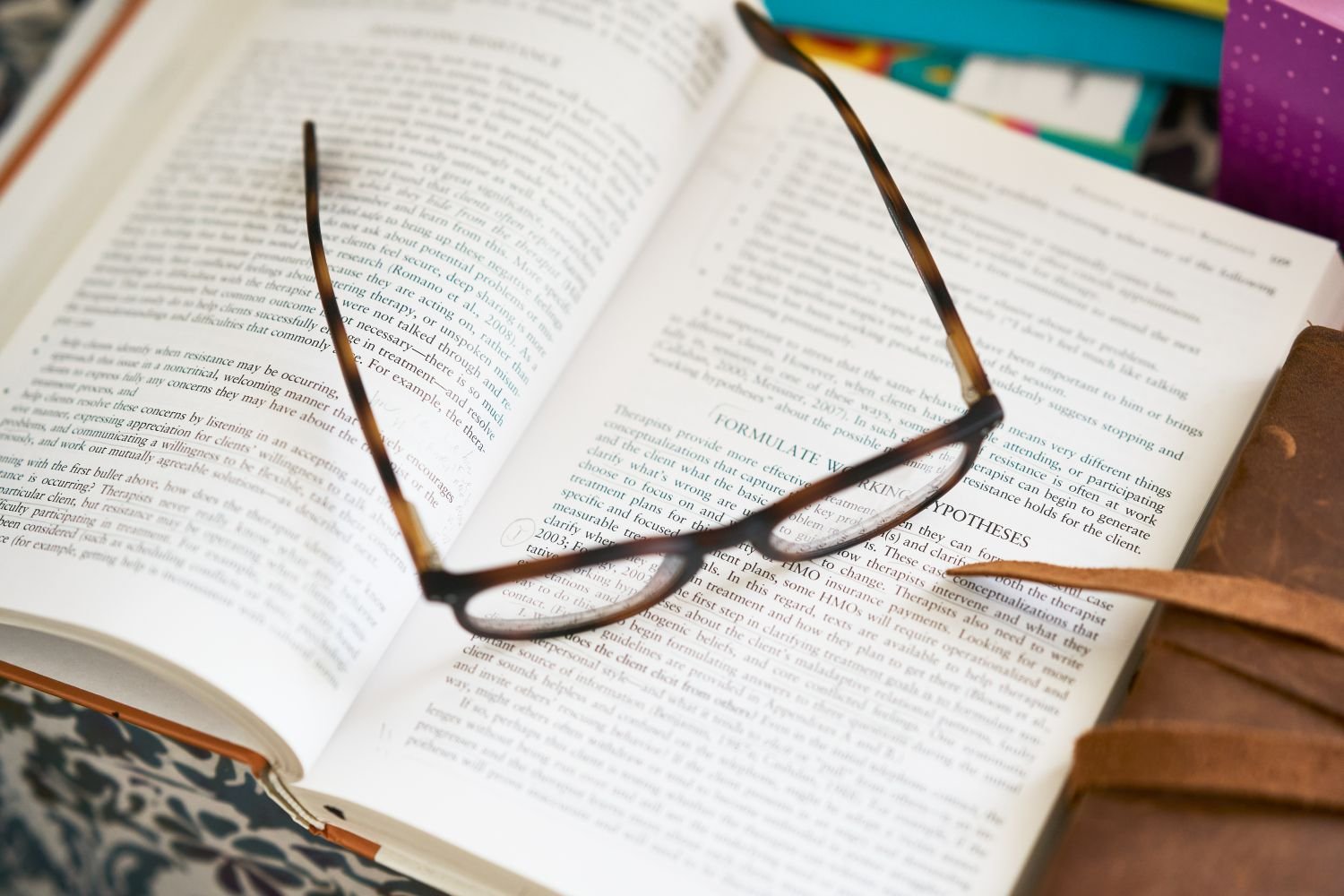Mental Health Resources - Books and glasses on a table