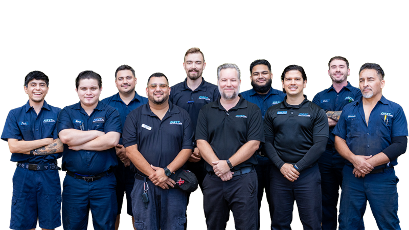 Group of nine diverse service technicians standing together, smiling, in uniform.