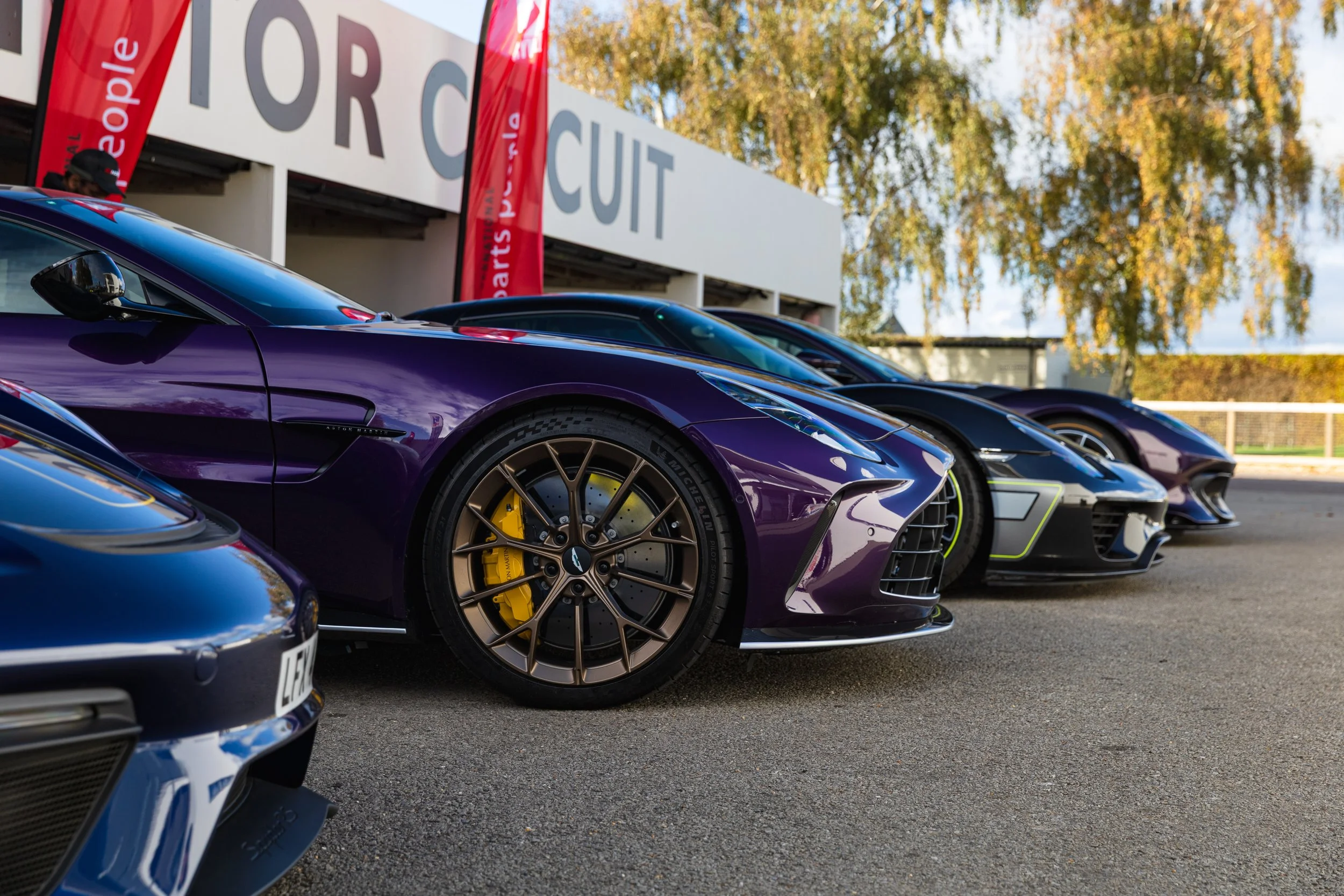 Aston Martin Vantage, Porsche 918 Spyder, Ferrari 812 Competizione in Goodwood paddocks