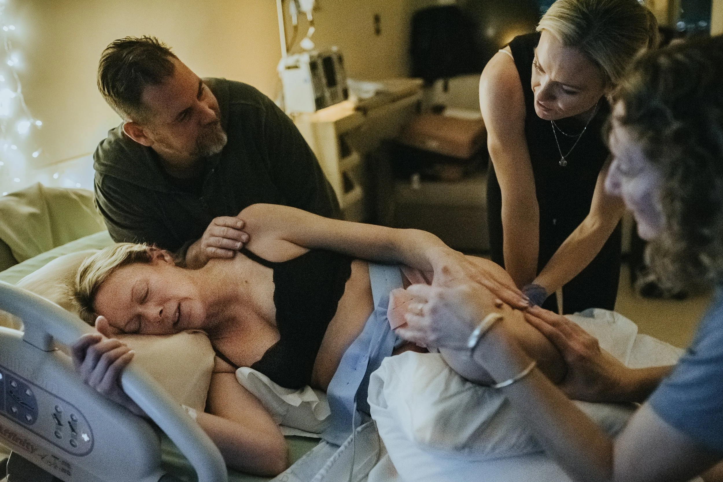 Mother in transition ssupported by her birth team in Hermosa Beach and documented by Los Angeles birth photographer Dear Birth