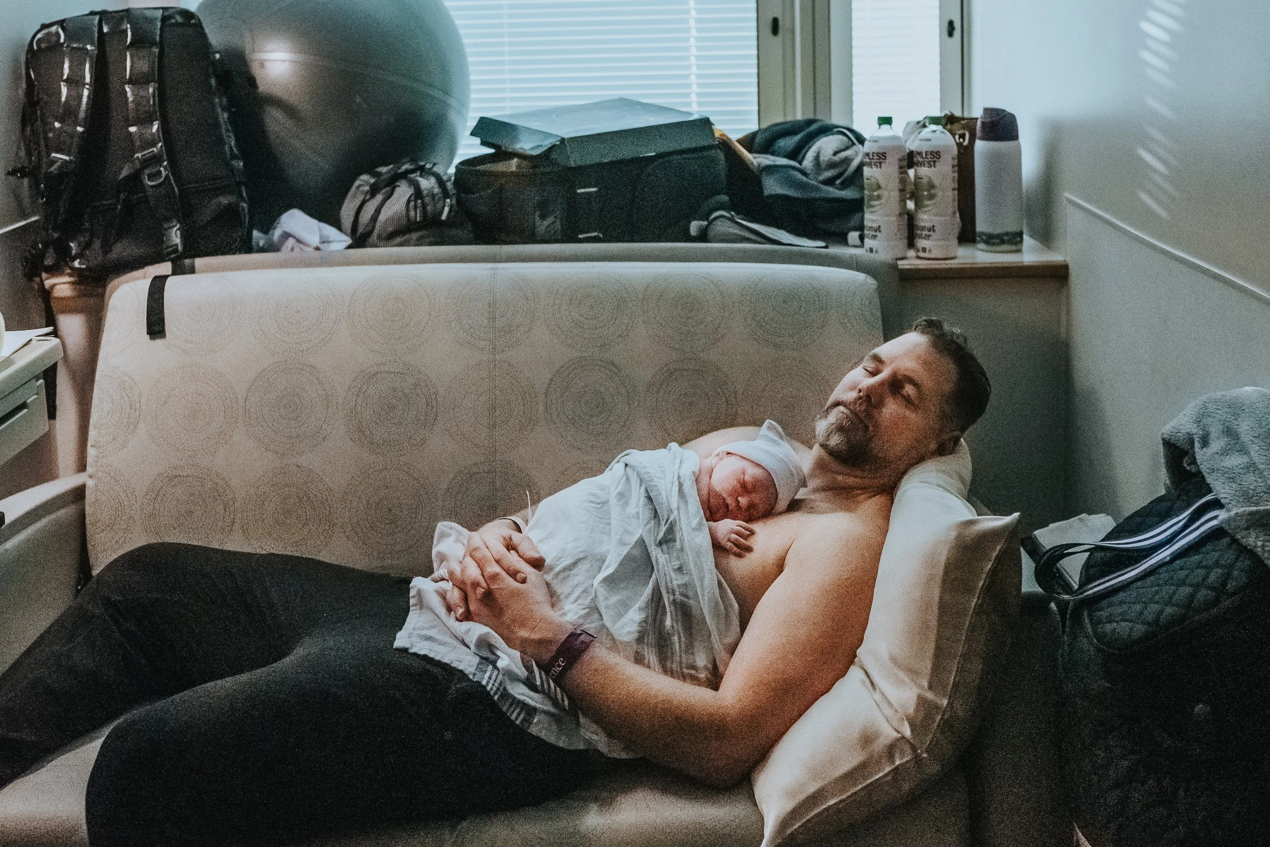 Daddy blisses out holding his son for the first time in a peaceful bliss documented by Los Angeles birth photographer Diana Hinek for Dear Birth