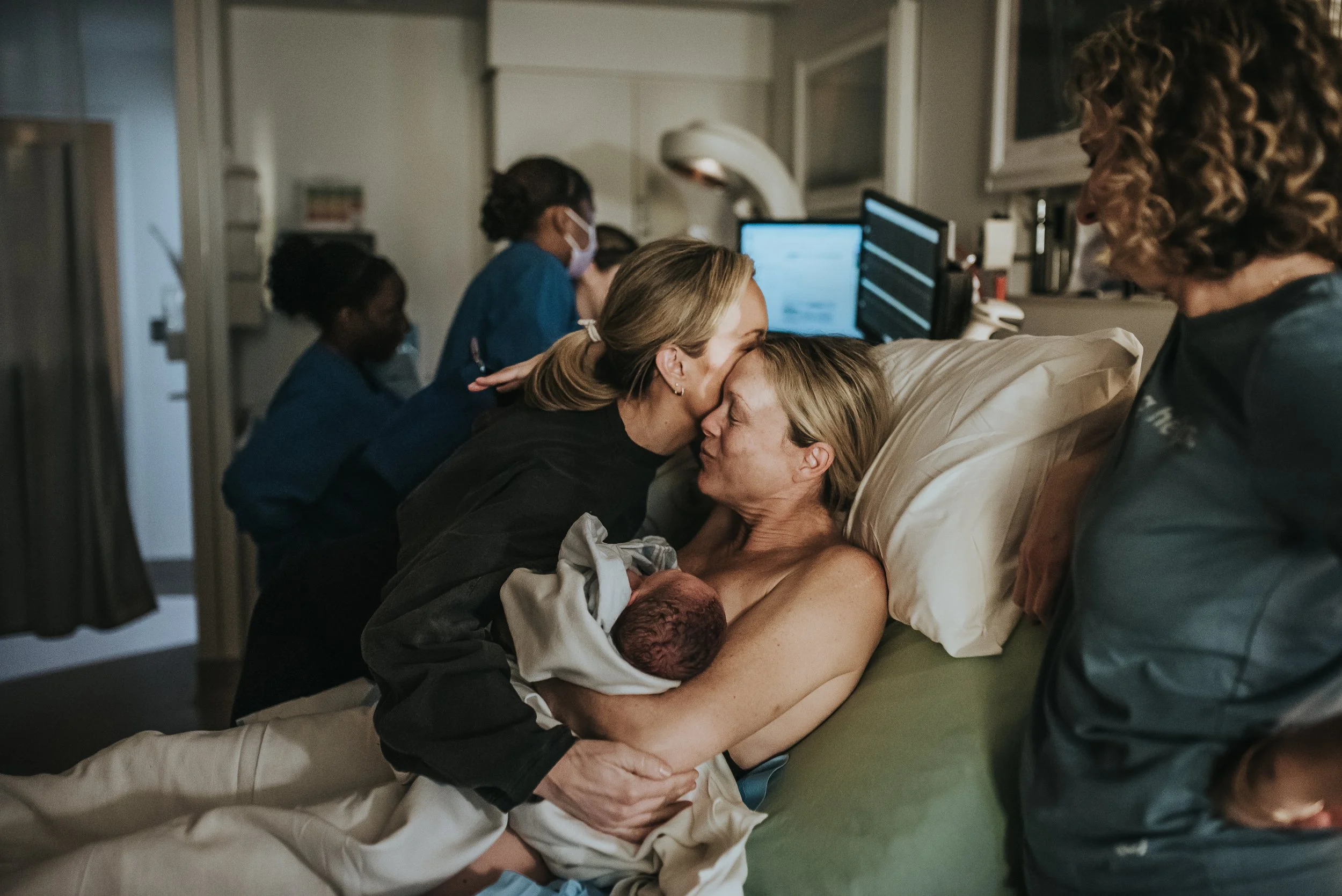 Midwife Julie congratulates mama for her hard work and  this moment isdocumented by Los Angeles birth photographer Dear Birth