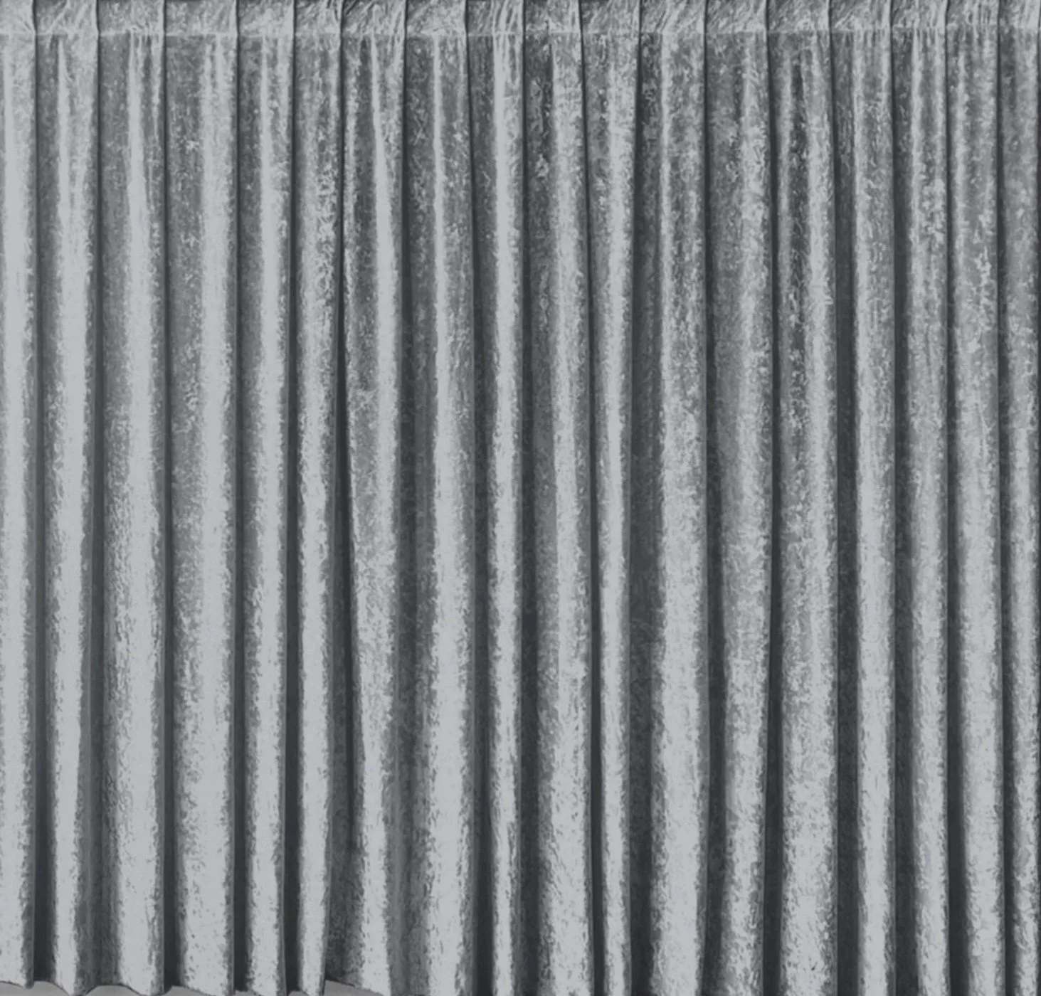 Close-up image of corrugated metal roofing or siding with vertical ridges and a weathered, textured surface.