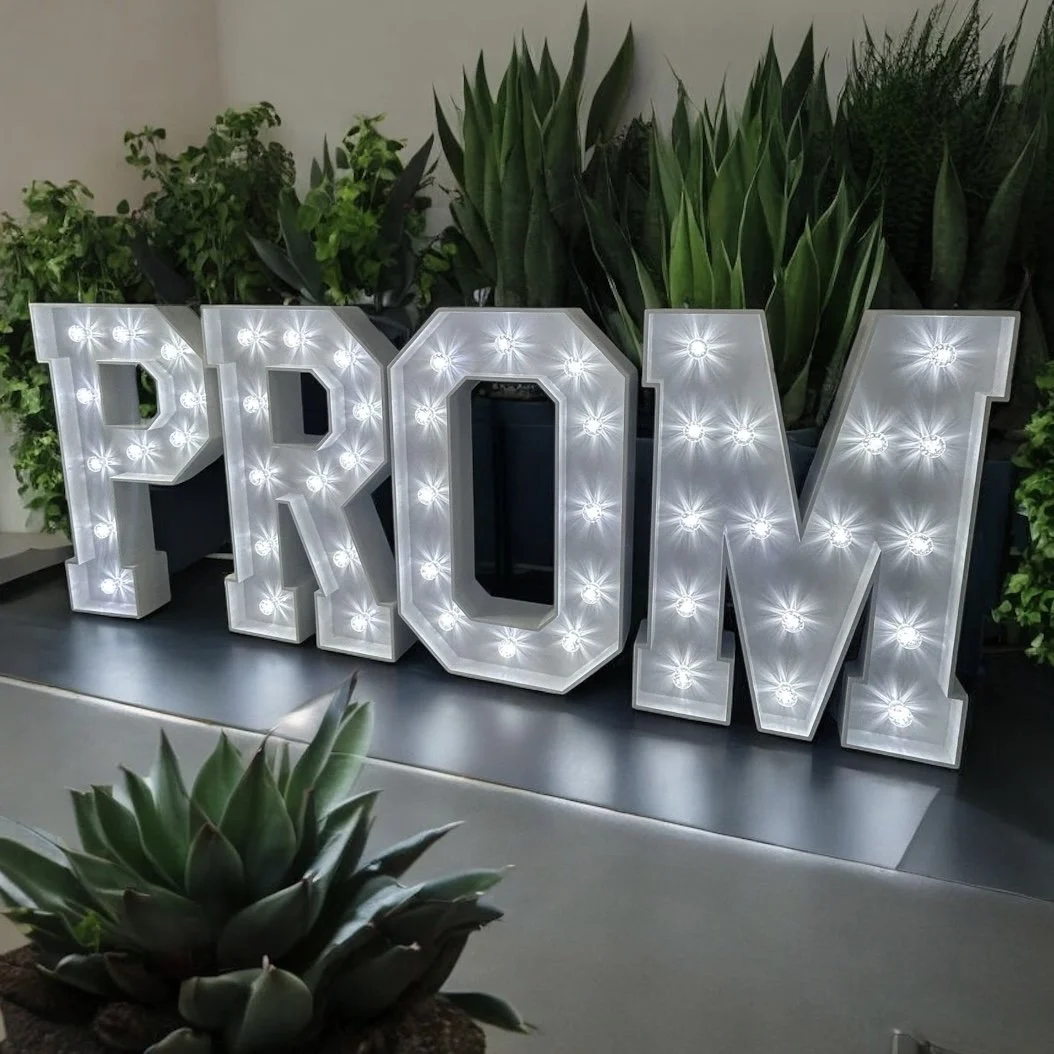 Large illuminated marquee letters spelling 'PRO'. 