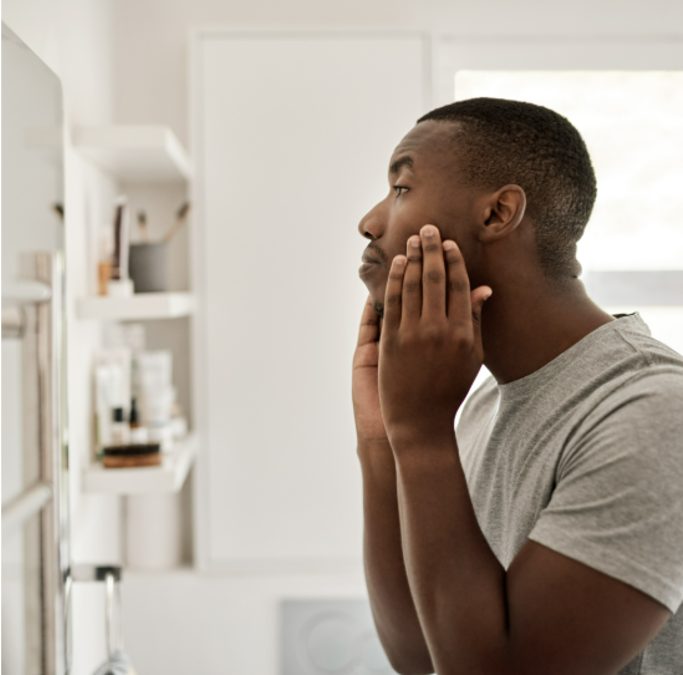 Male putting on face skincare