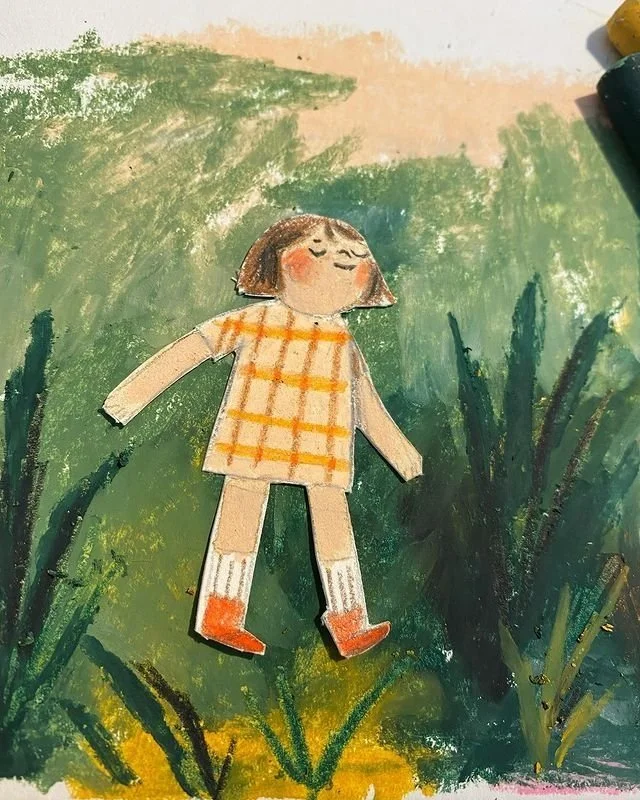 A hand-drawn illustration of a girl with a bob haircut, wearing a yellow and orange checkered dress, white socks, and orange shoes, lying on green grass with tall plants on either side.